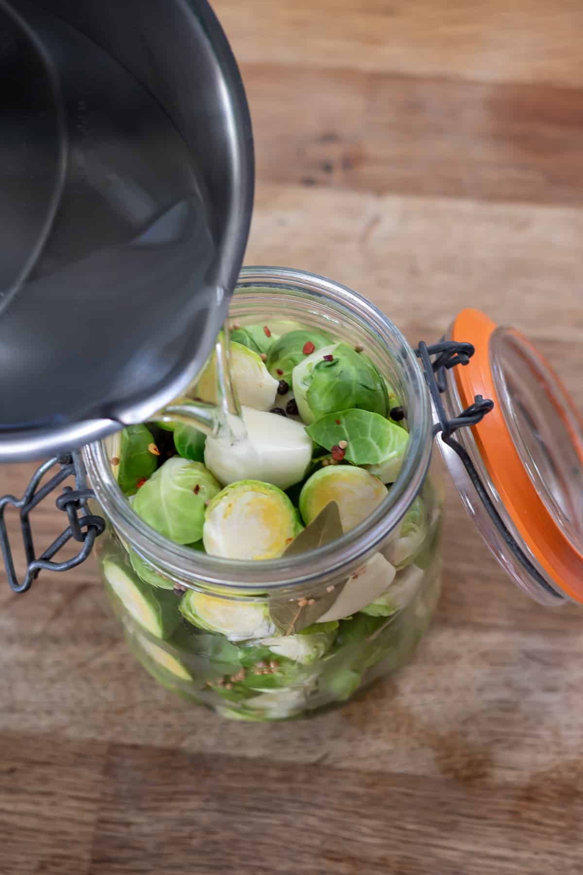 Pouring the brine into the jar of sprouts.