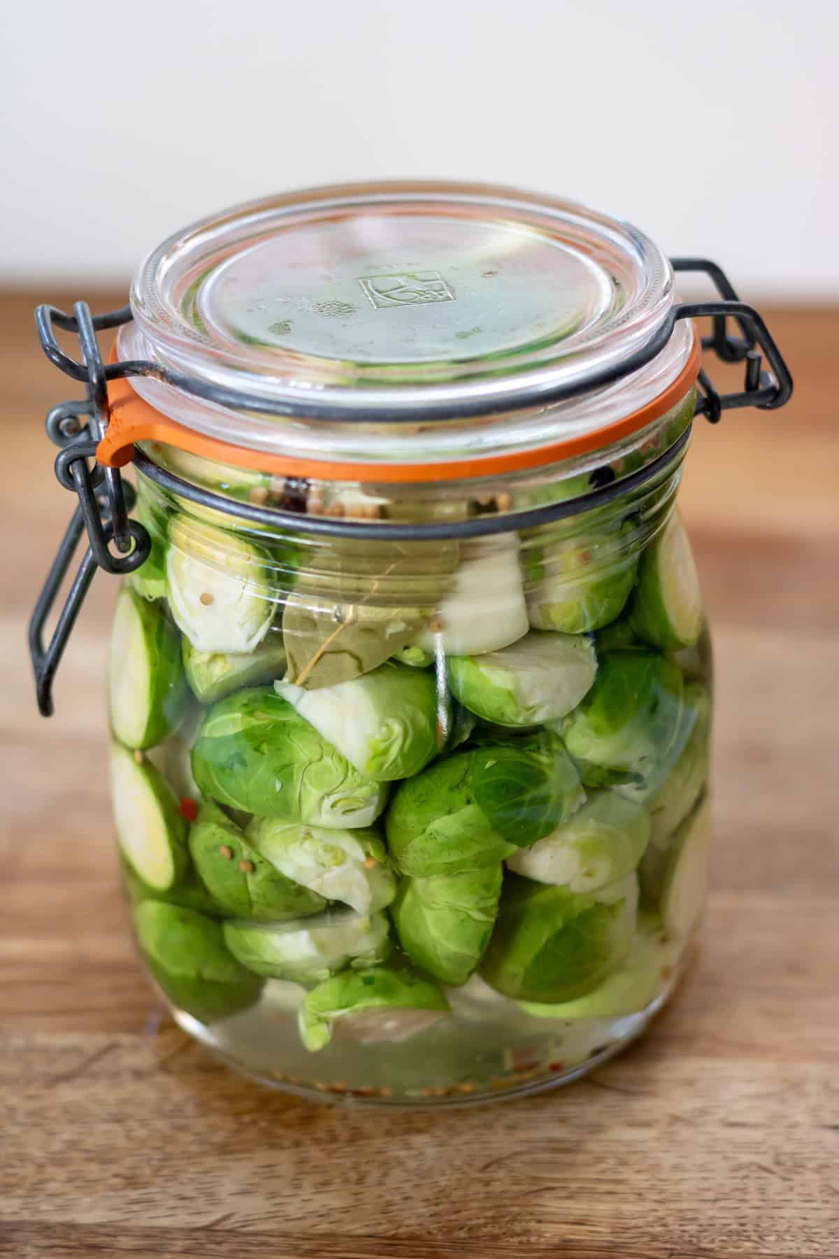 Sealed jar of brussels sprouts in pickling brine.