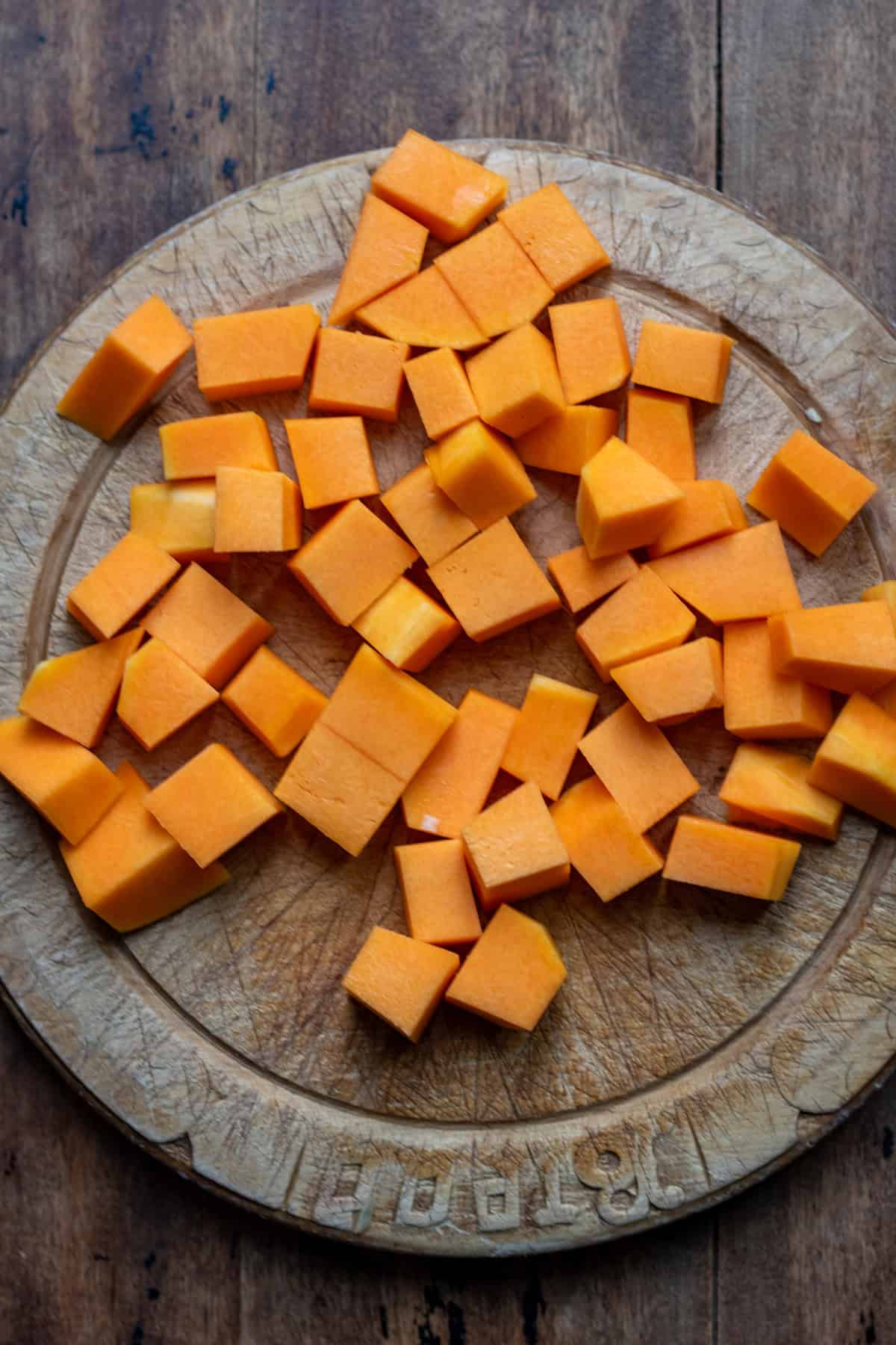 Cubes of butternut squash on a cutting board.