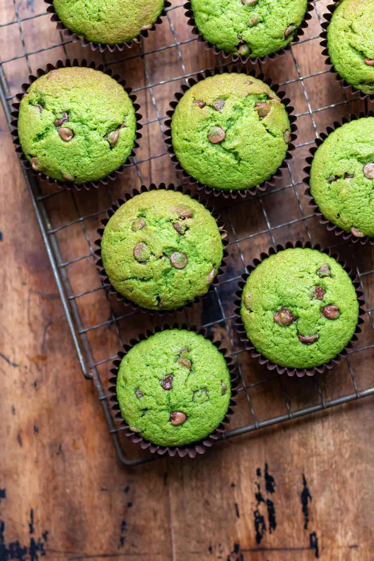 Chocolate chip kale muffins cooling on a wire rack.