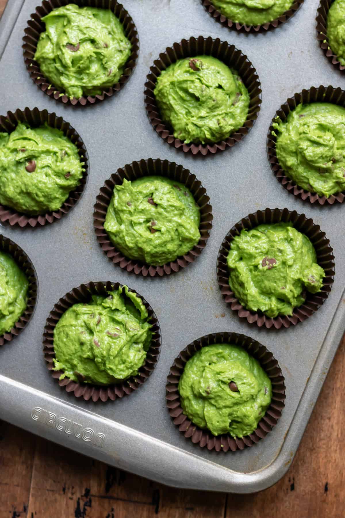 Kale muffin batter in muffin pan.