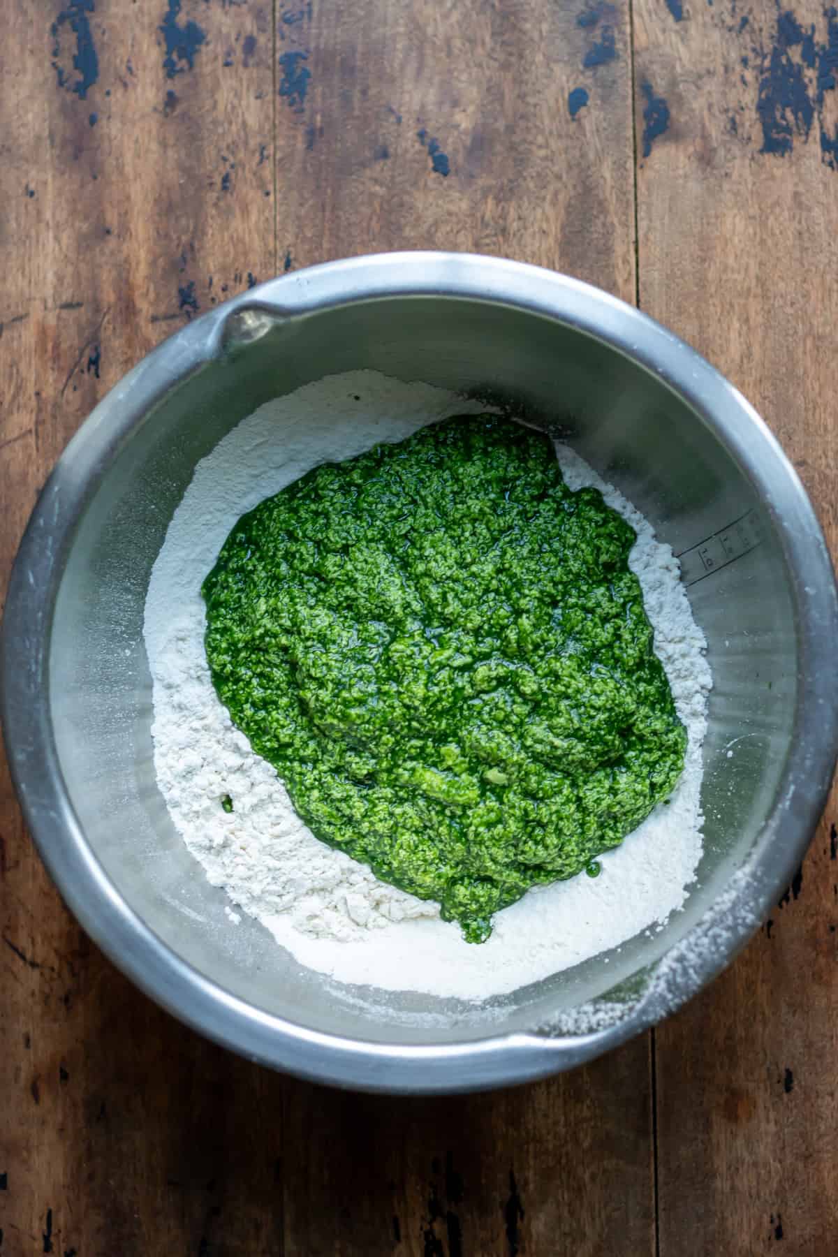 Wet ingredients added to the bowl of dry ingredients.