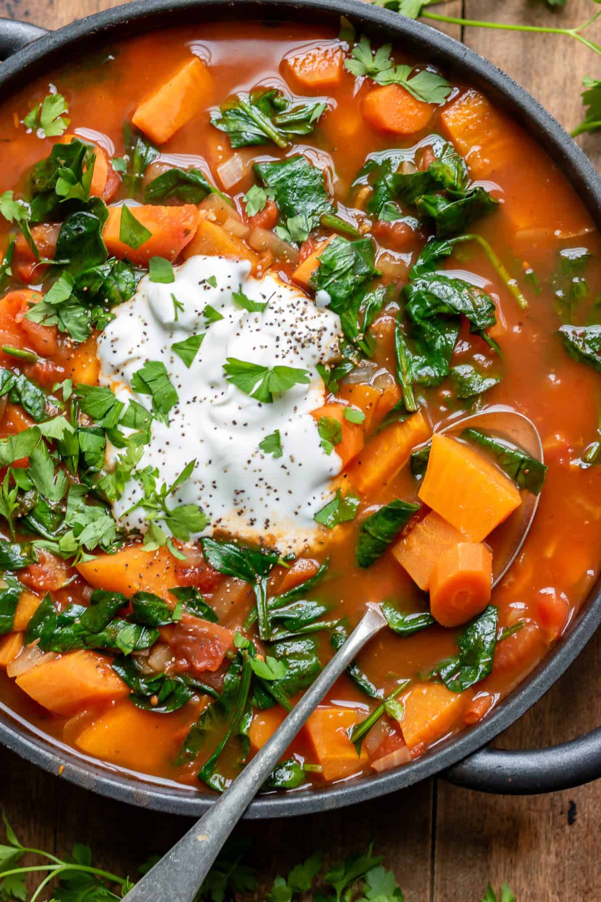 A spoon in a dish of soup.