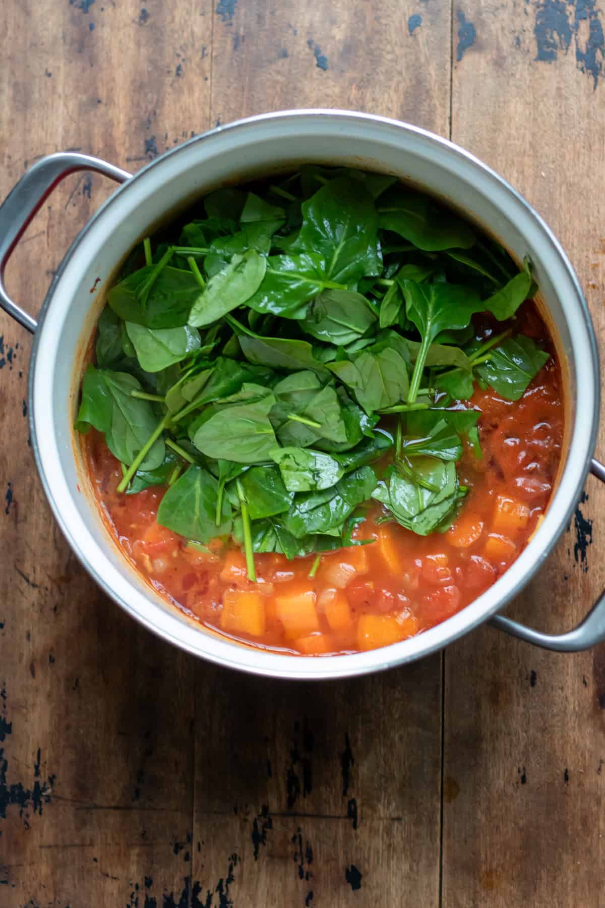 Spinach leaves added to the pot.