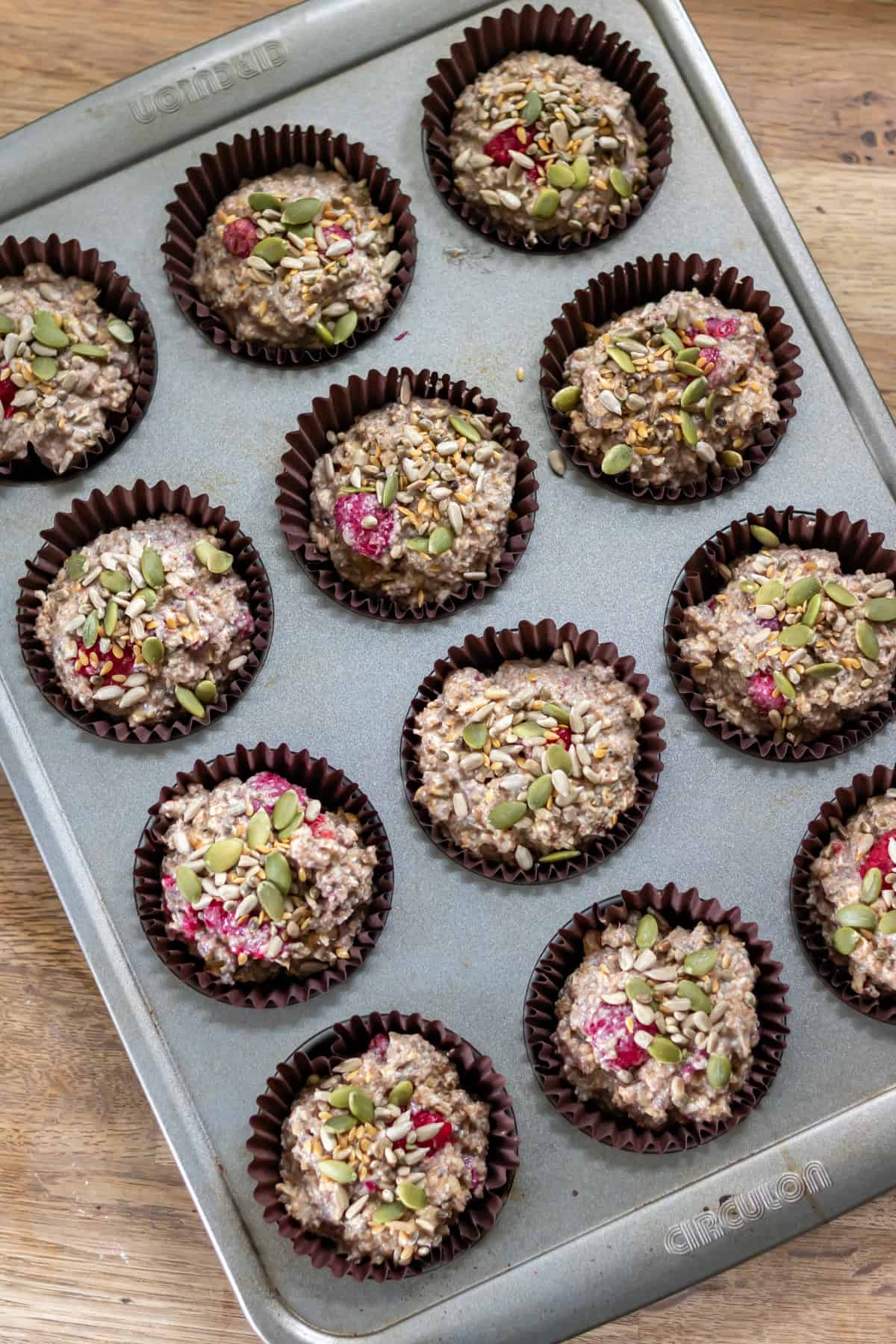 Seeds added to the uncooked muffins.