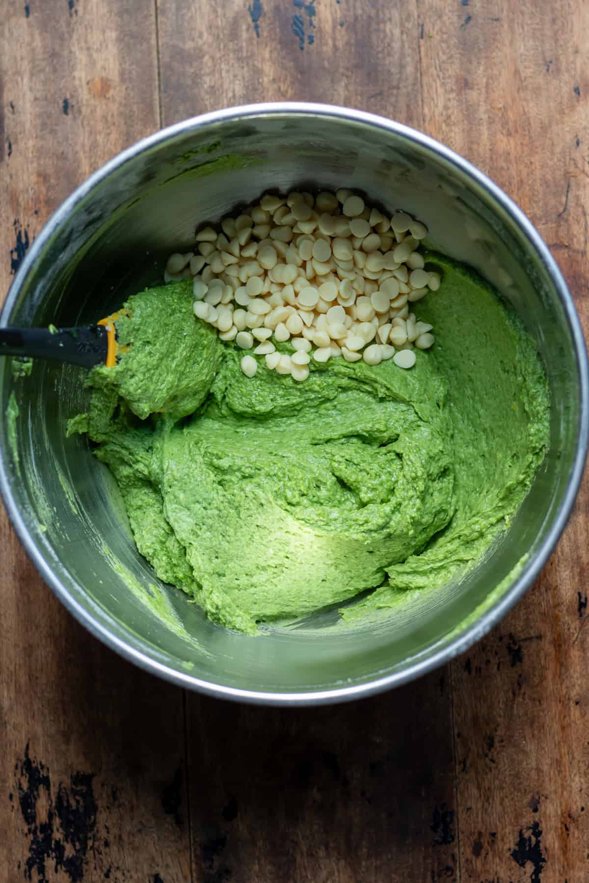 White chocolate chips added to the spinach muffin mixture.