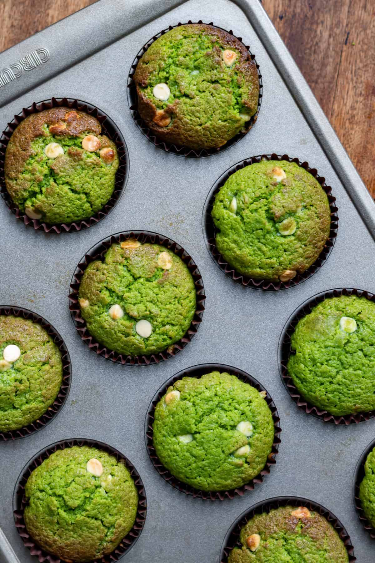 Muffin pan of baked lemon spinach muffins.