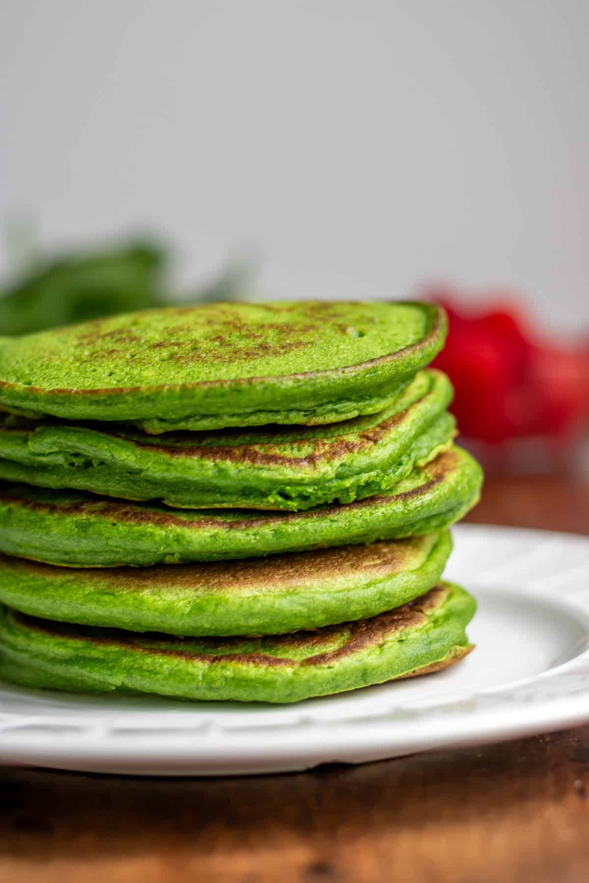 Close up of a stack of spinach pancakes.
