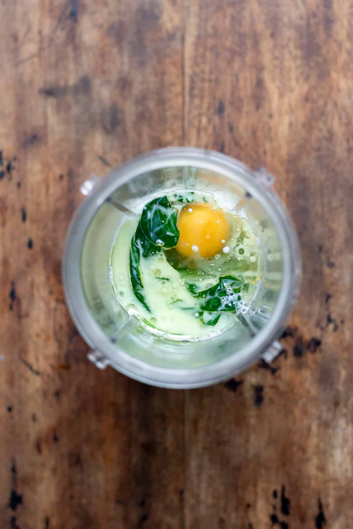 Spinach, milk, oil and egg in a blender.