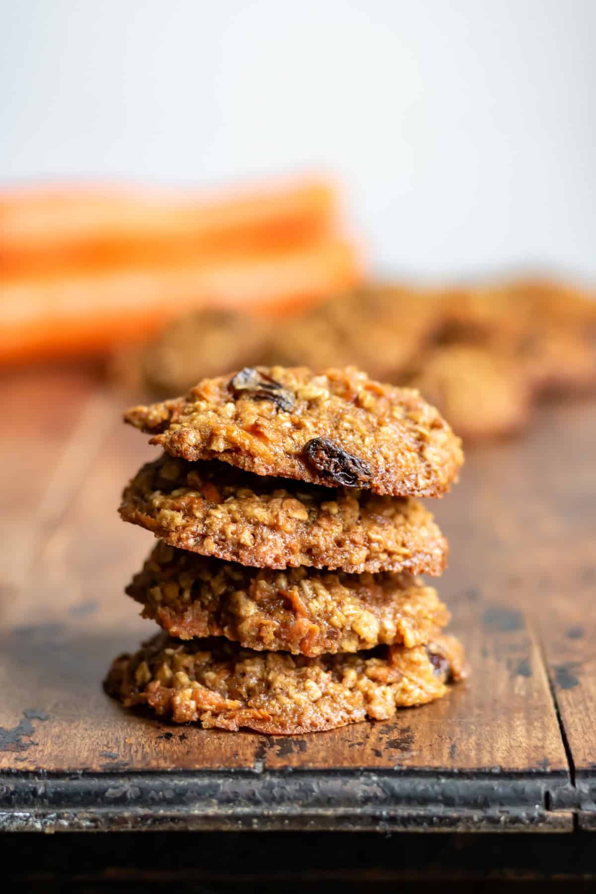 Stack of carrot cookies on a wooden table.