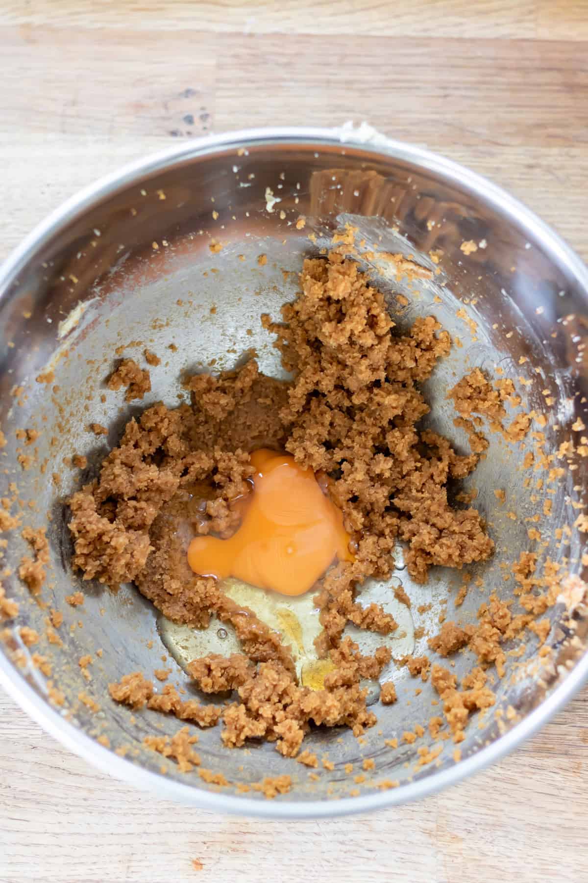 Egg and vanilla added to the bowl of creamed butter and sugar.