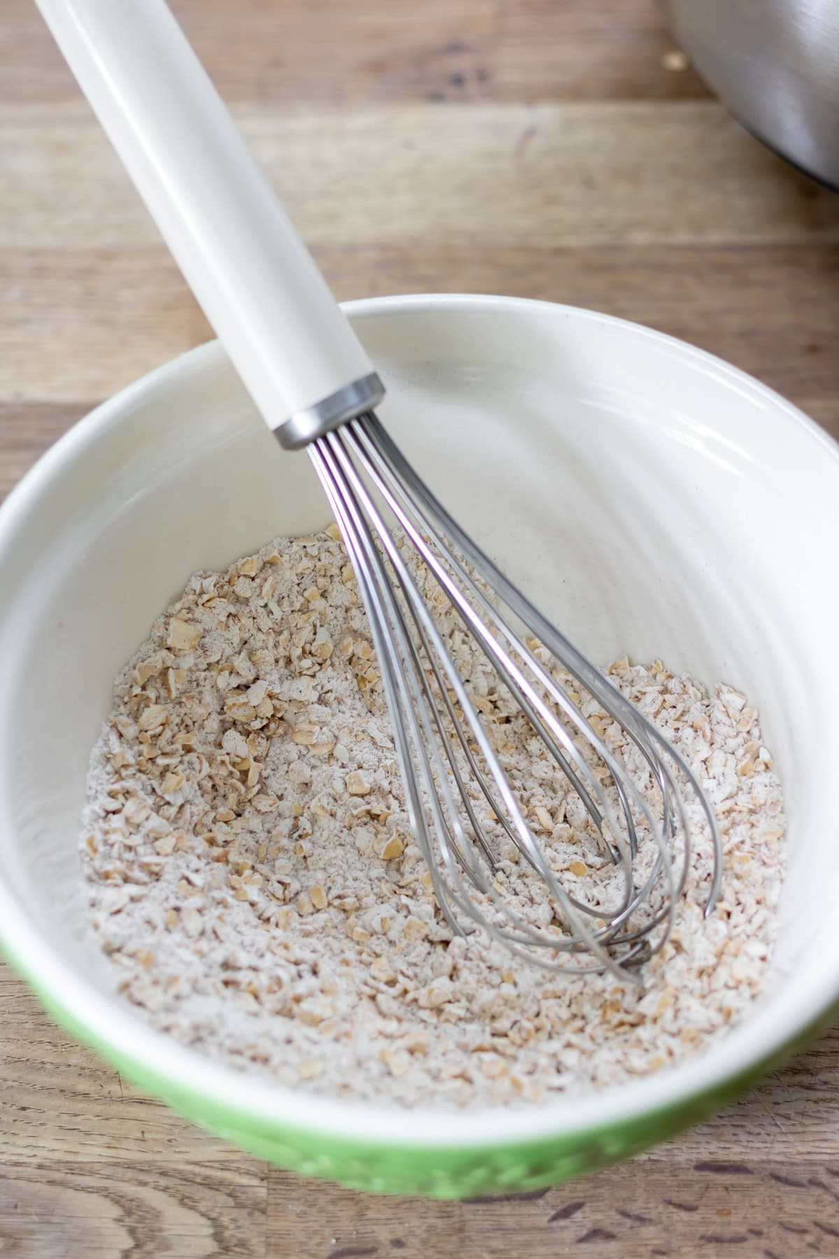 Whisking the oats, flour, soda and salt in a bowl.