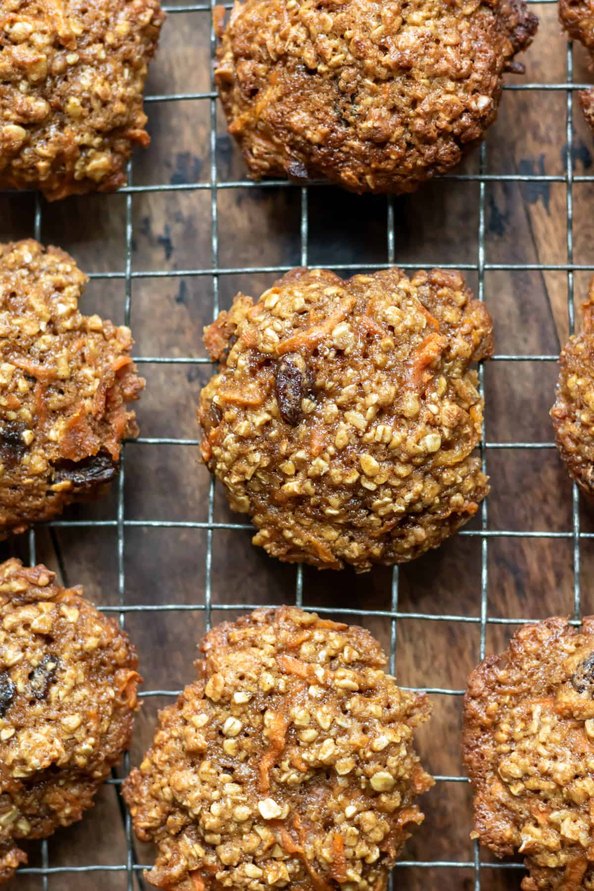 Close up of an oatmeal carrot cookie cooling on a wire rack.