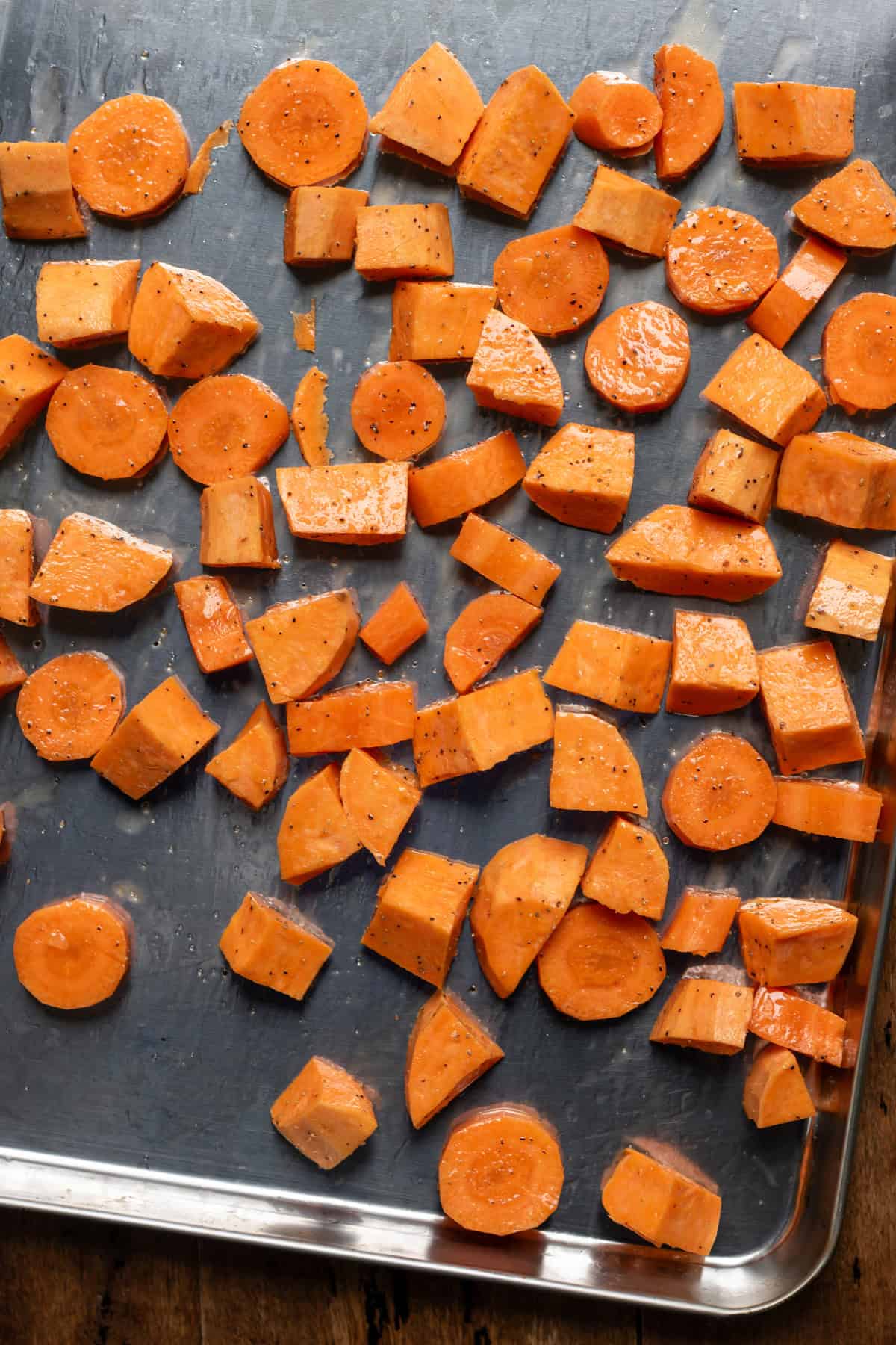 Vegetables spread onto a baking sheet.