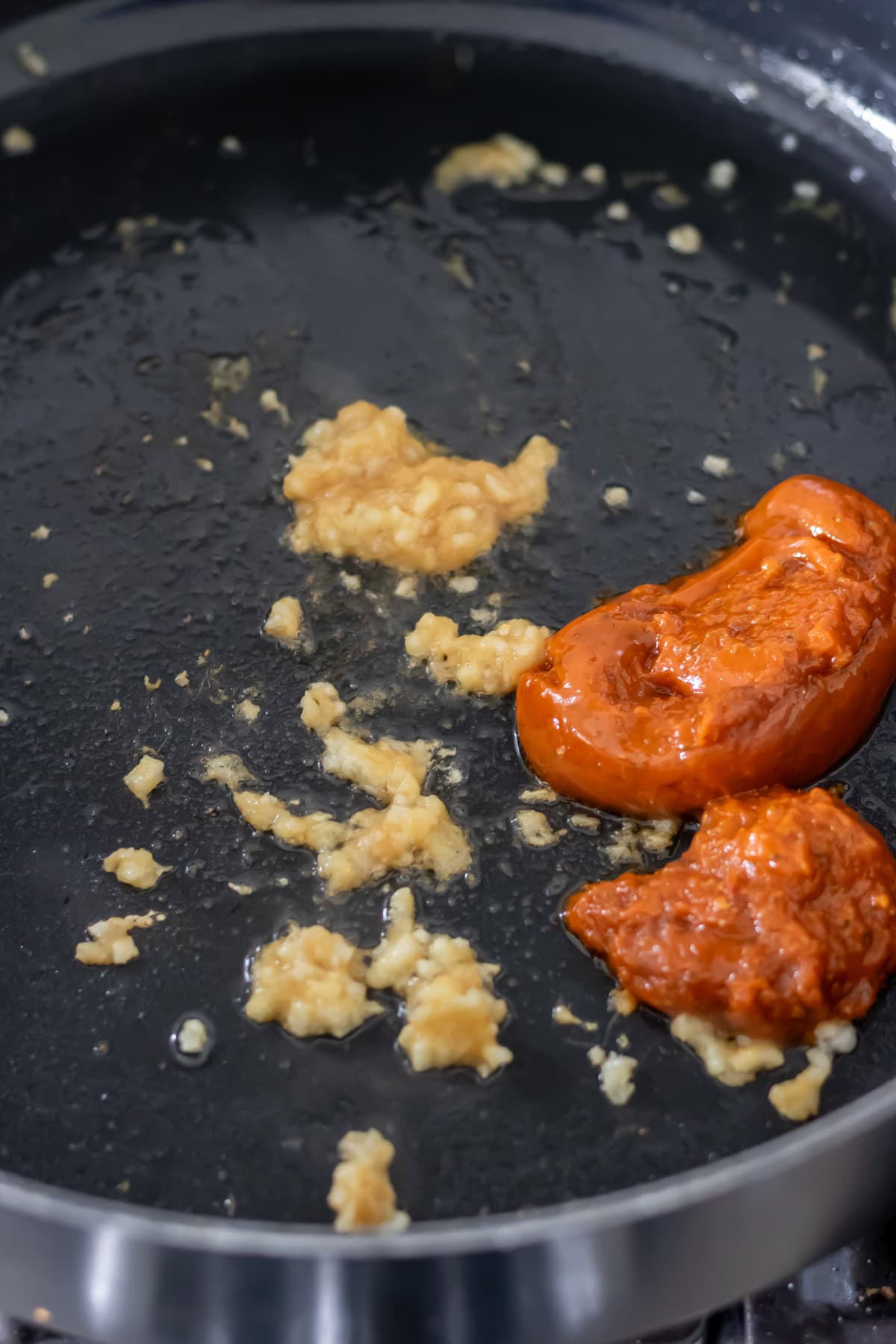 Ginger, garlic and thai red curry paste in a pan.