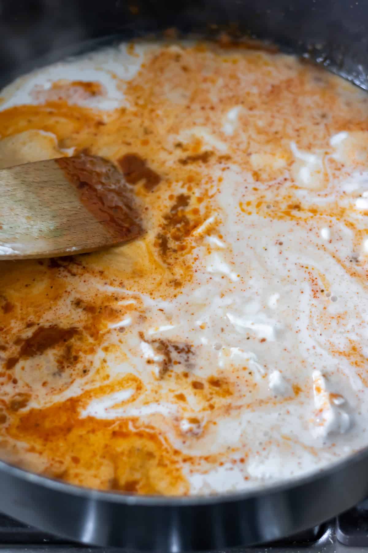 Coconut milk added to a pan.
