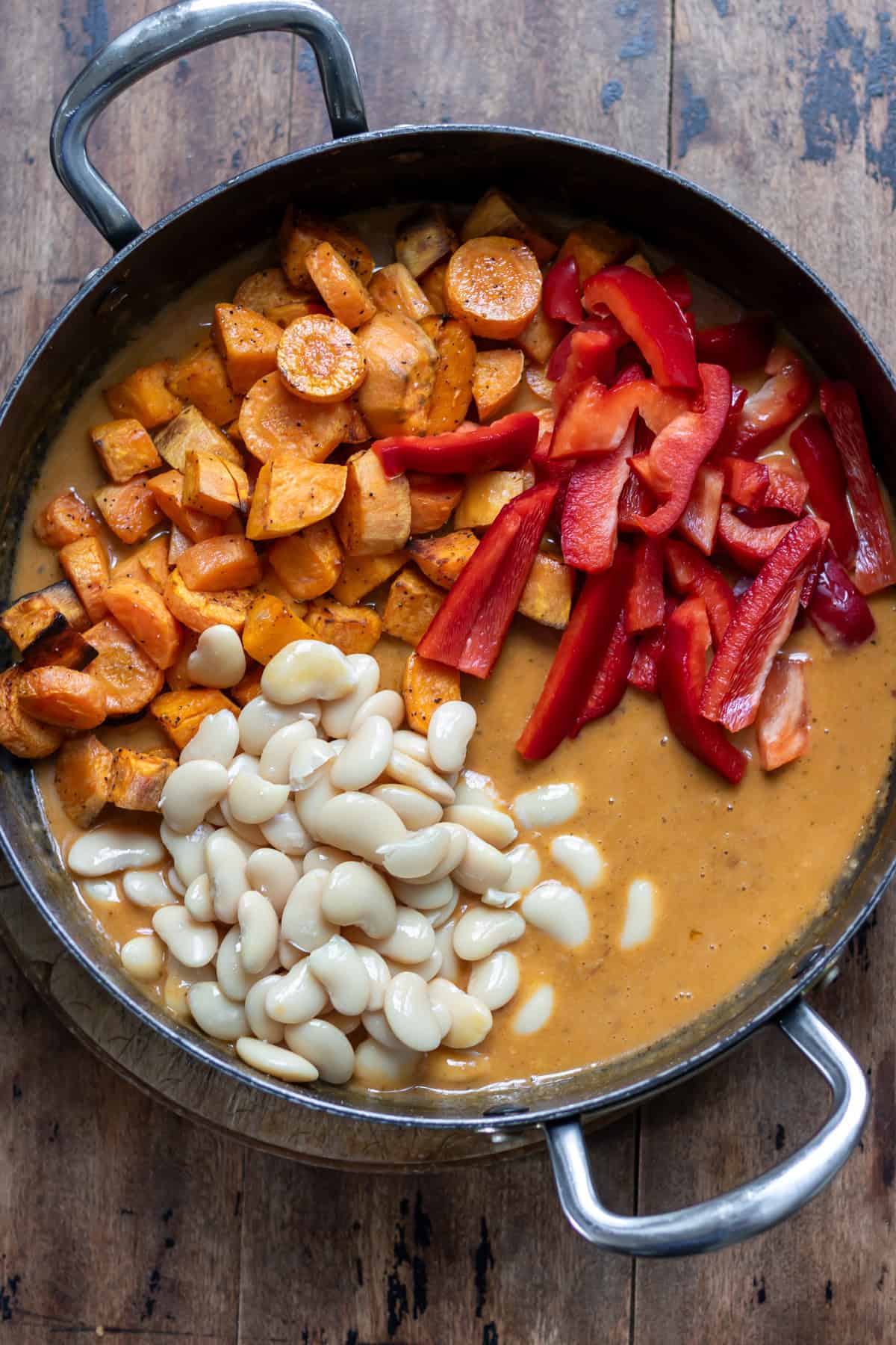 Roasted vegetables, sliced red bell pepper and drained butter beans added to the Thai red curry sauce.