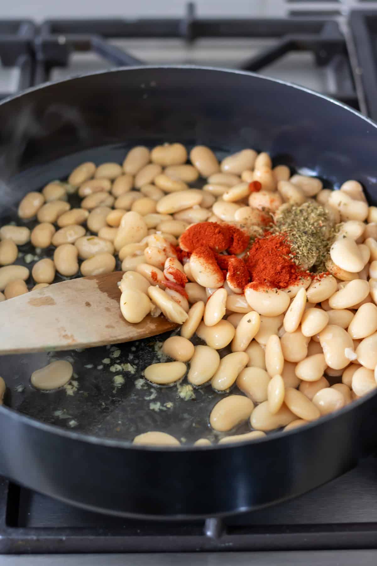 Butter beans, oregano and smoked paprika added to the pan.
