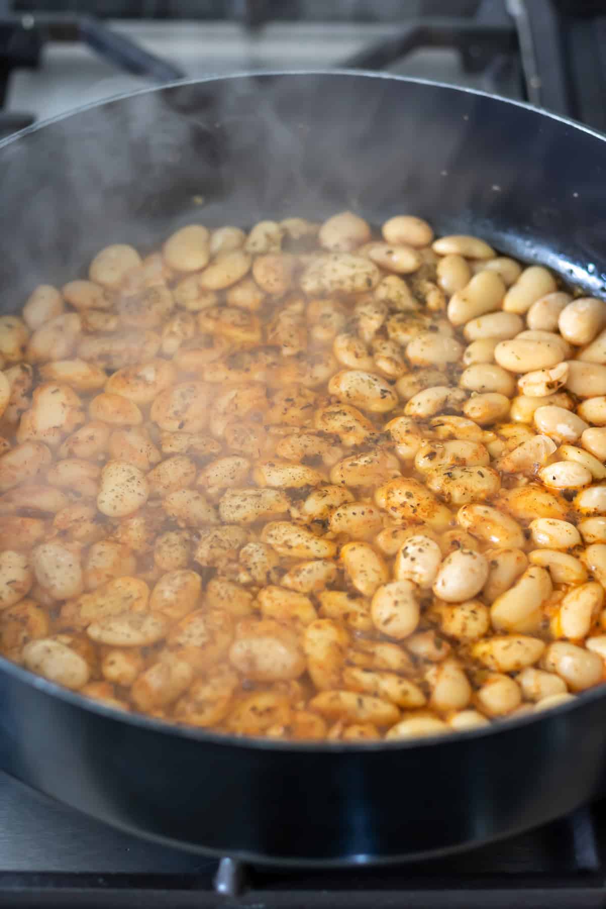 Simmering smoky garlic butterbeans.