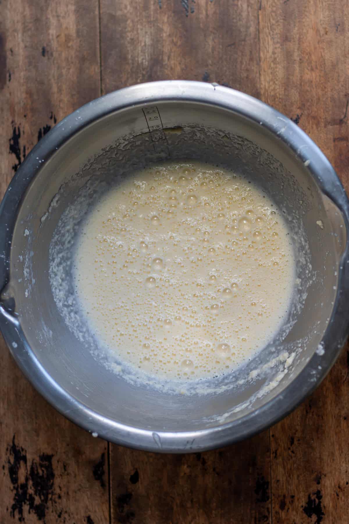 Beaten wet ingredients in a mixing bowl.