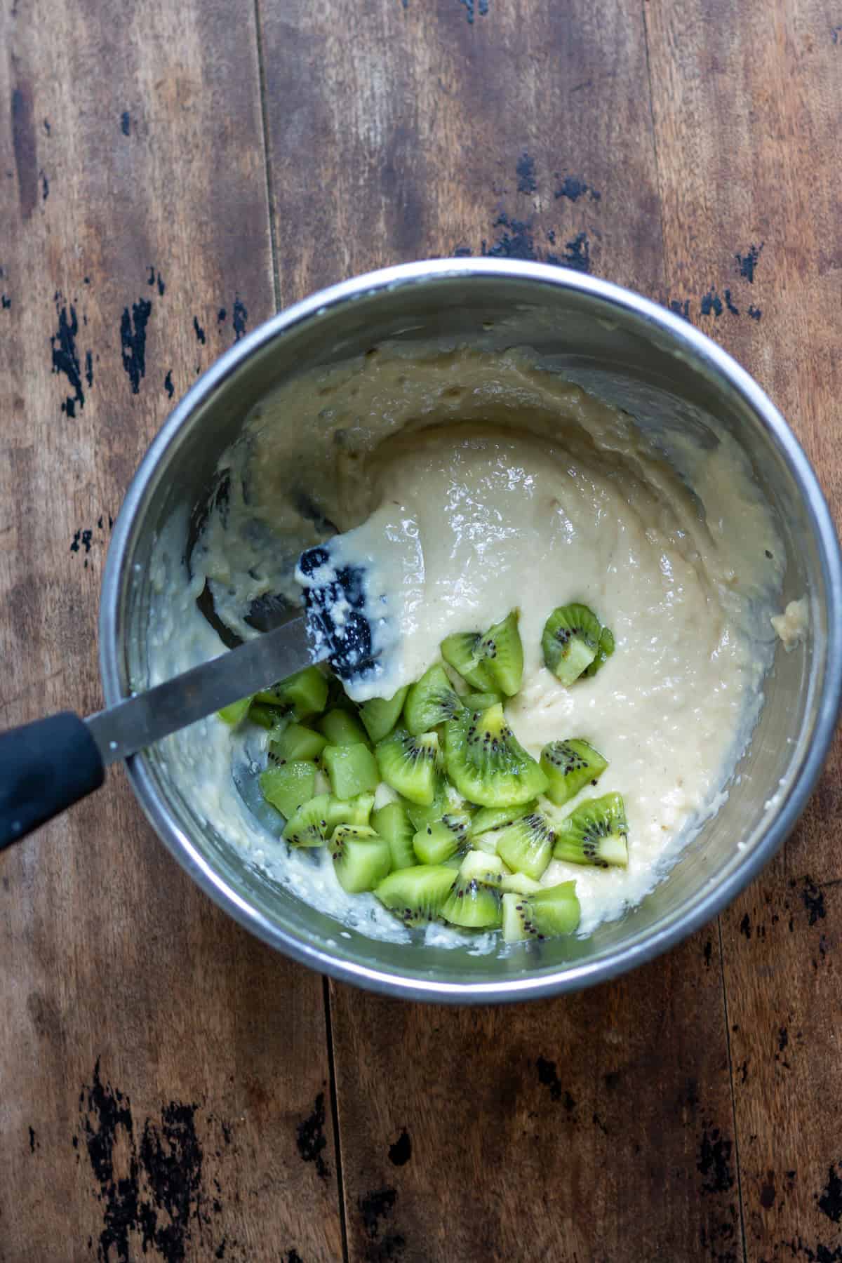 Chopped kiwis added to the muffin batter.