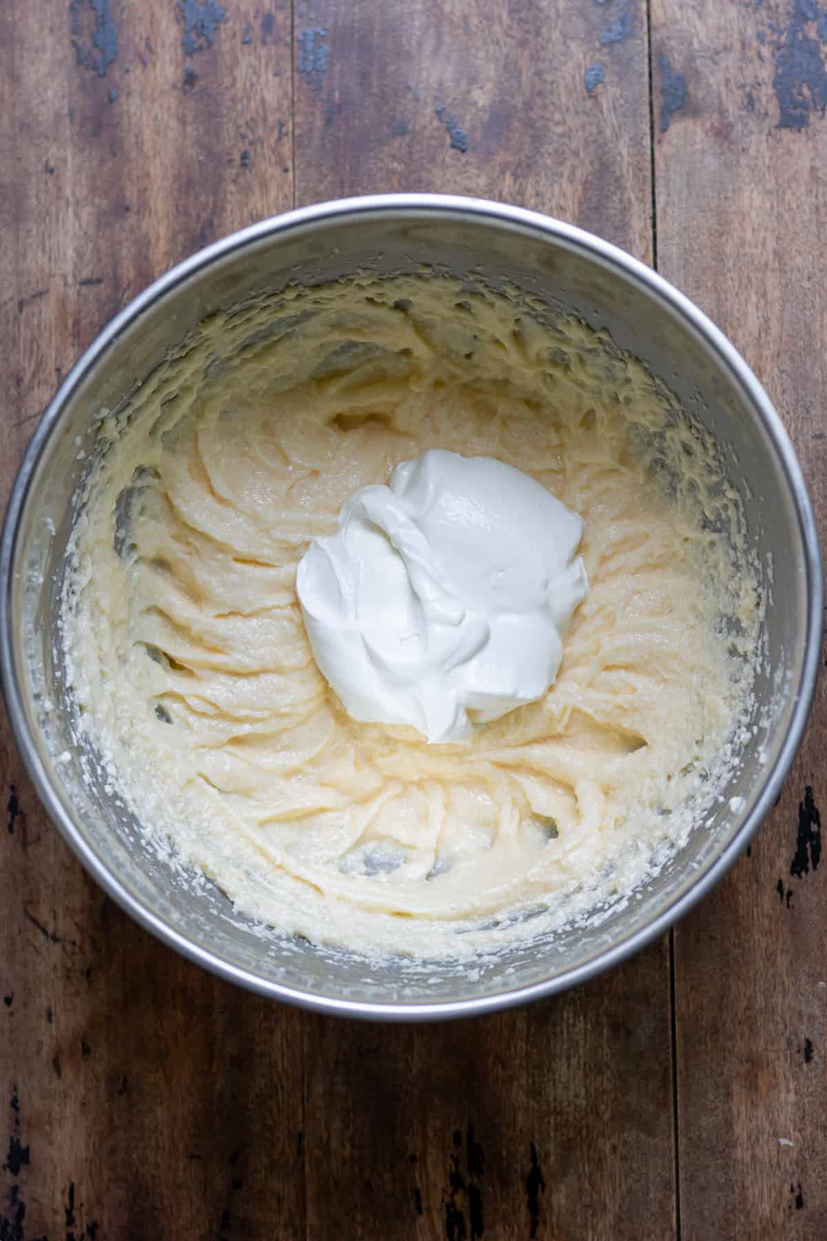 Sour cream added to beaten butter, sugar and eggs.