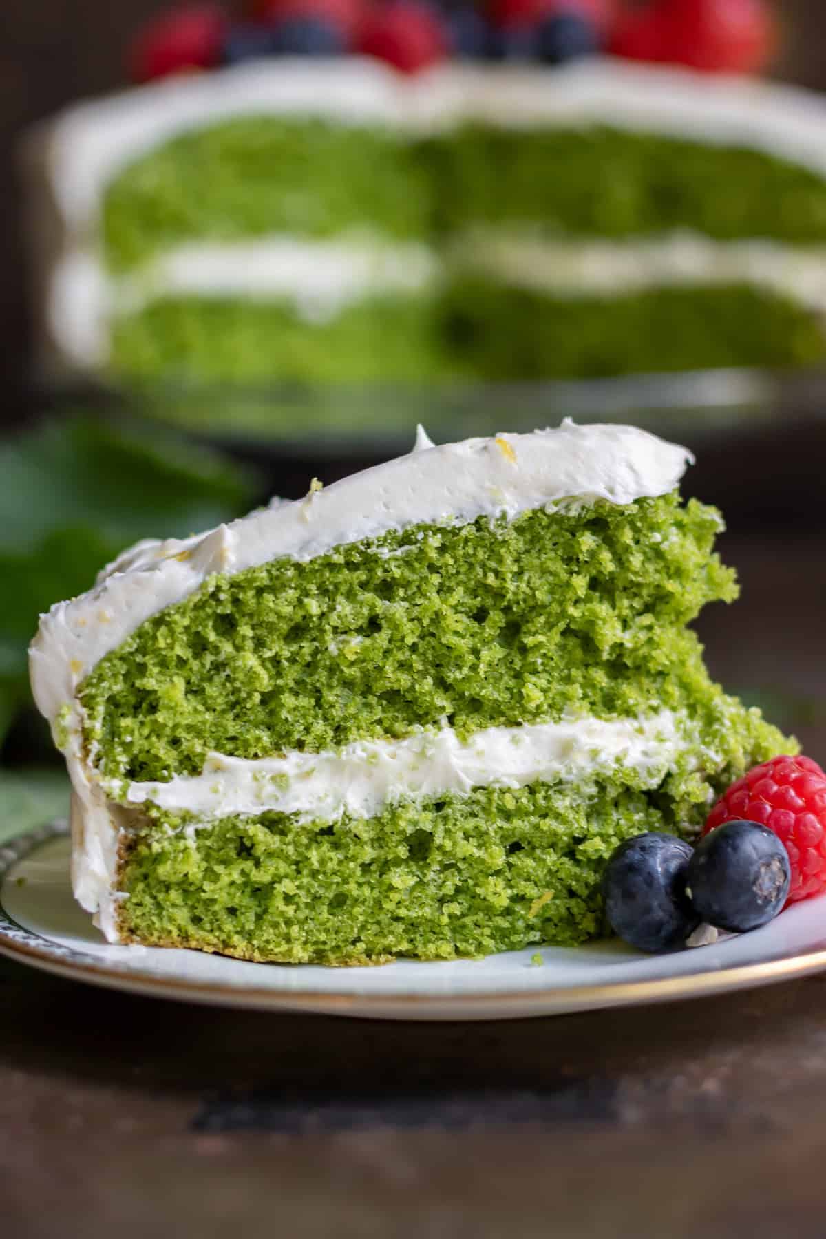 Close up of a slice of naturally bright green stinging nettle cake.