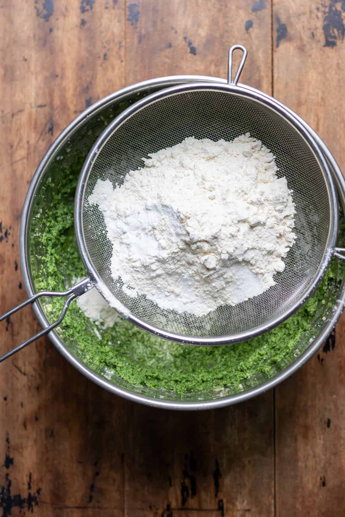 Sifting the dry ingredients into the mixing bowl.