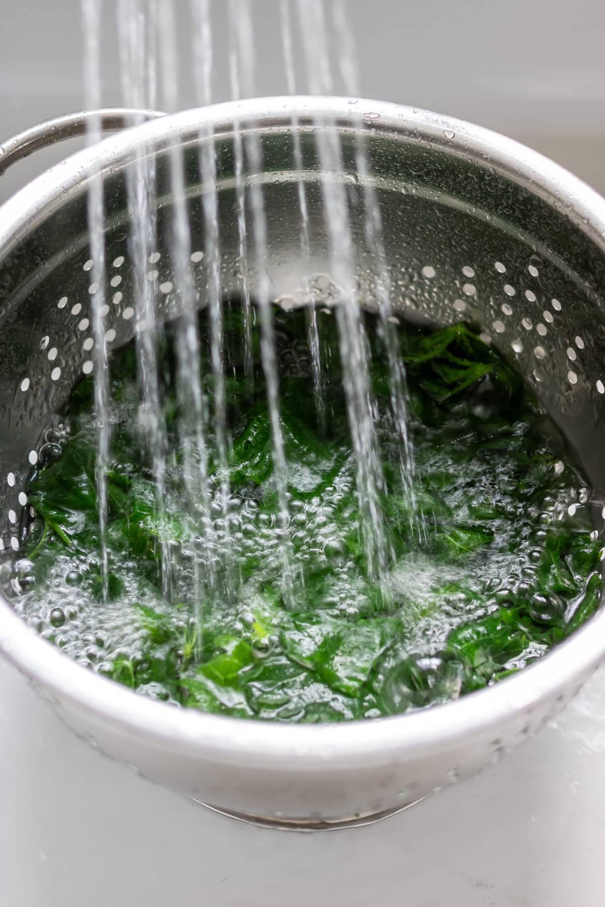Rinsing the boiled stinging nettles.