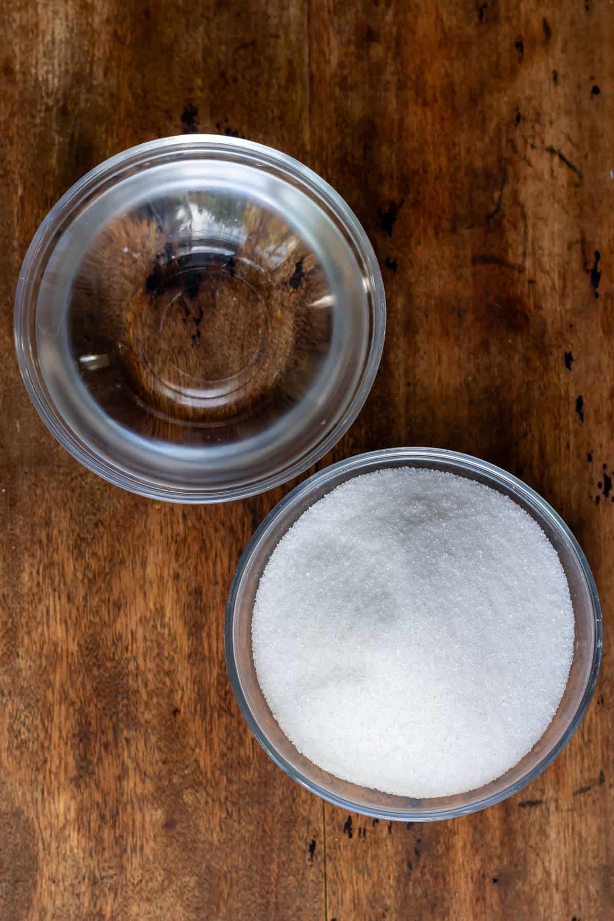 Bowl of water and bowl of sugar.