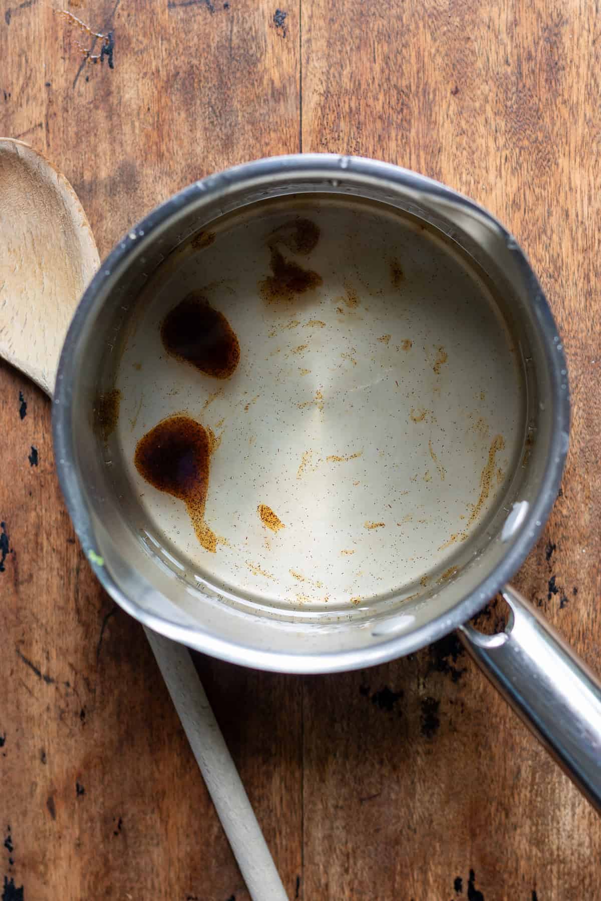 Vanilla bean paste added to the pot of simple syrup.