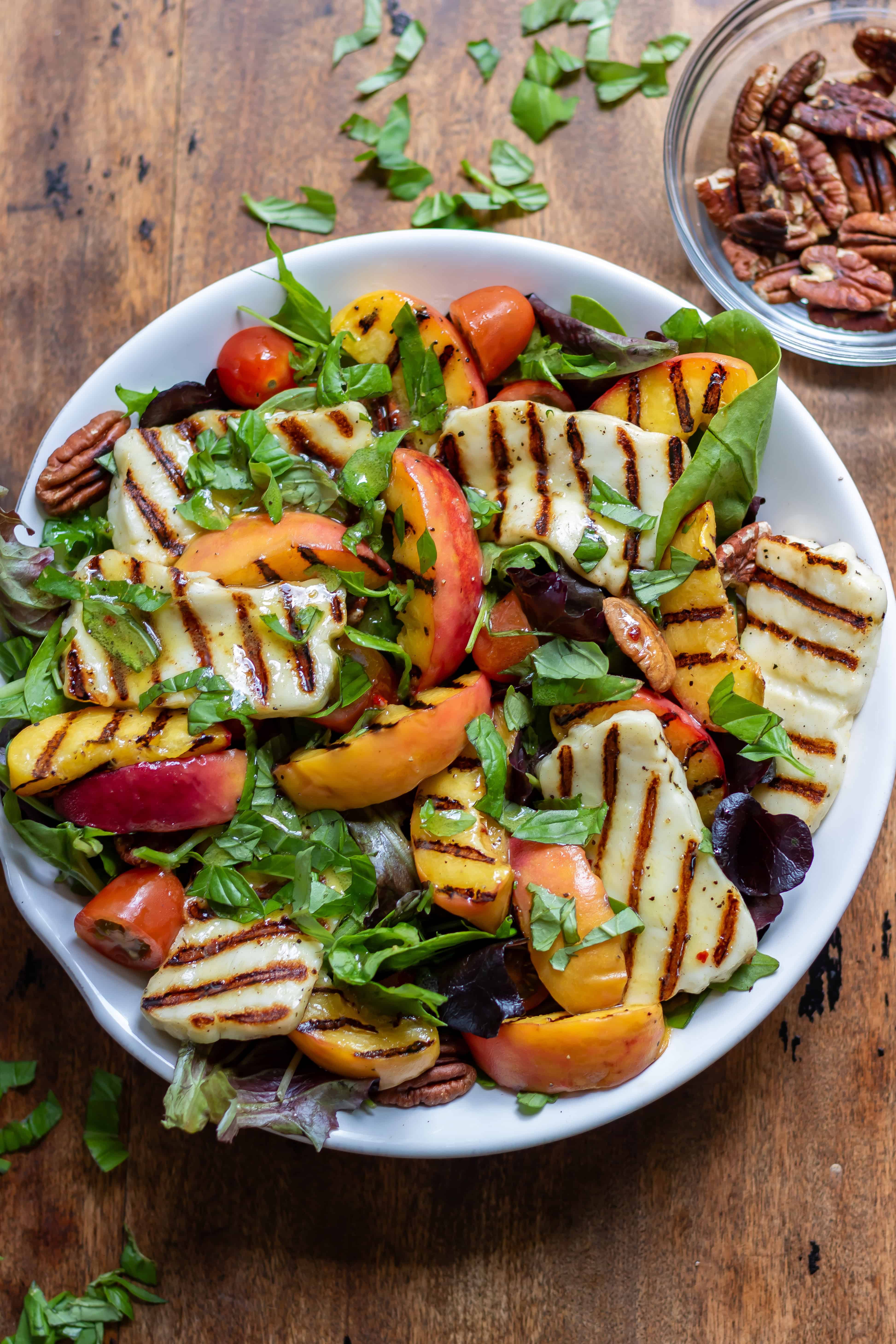 A serving dish of hot honey grilled halloumi peach salad.