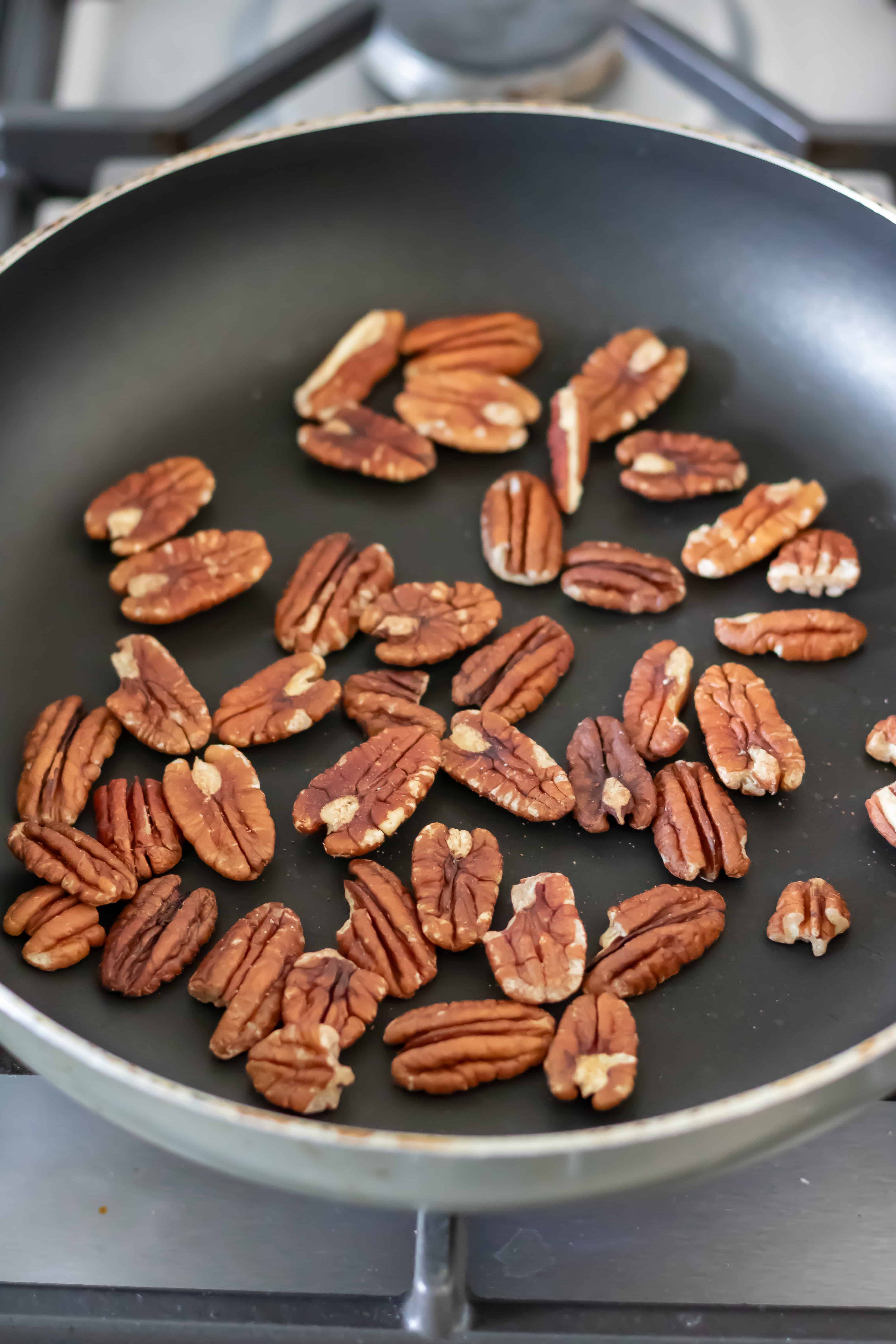 Toasting pecans in a dry frying pan.