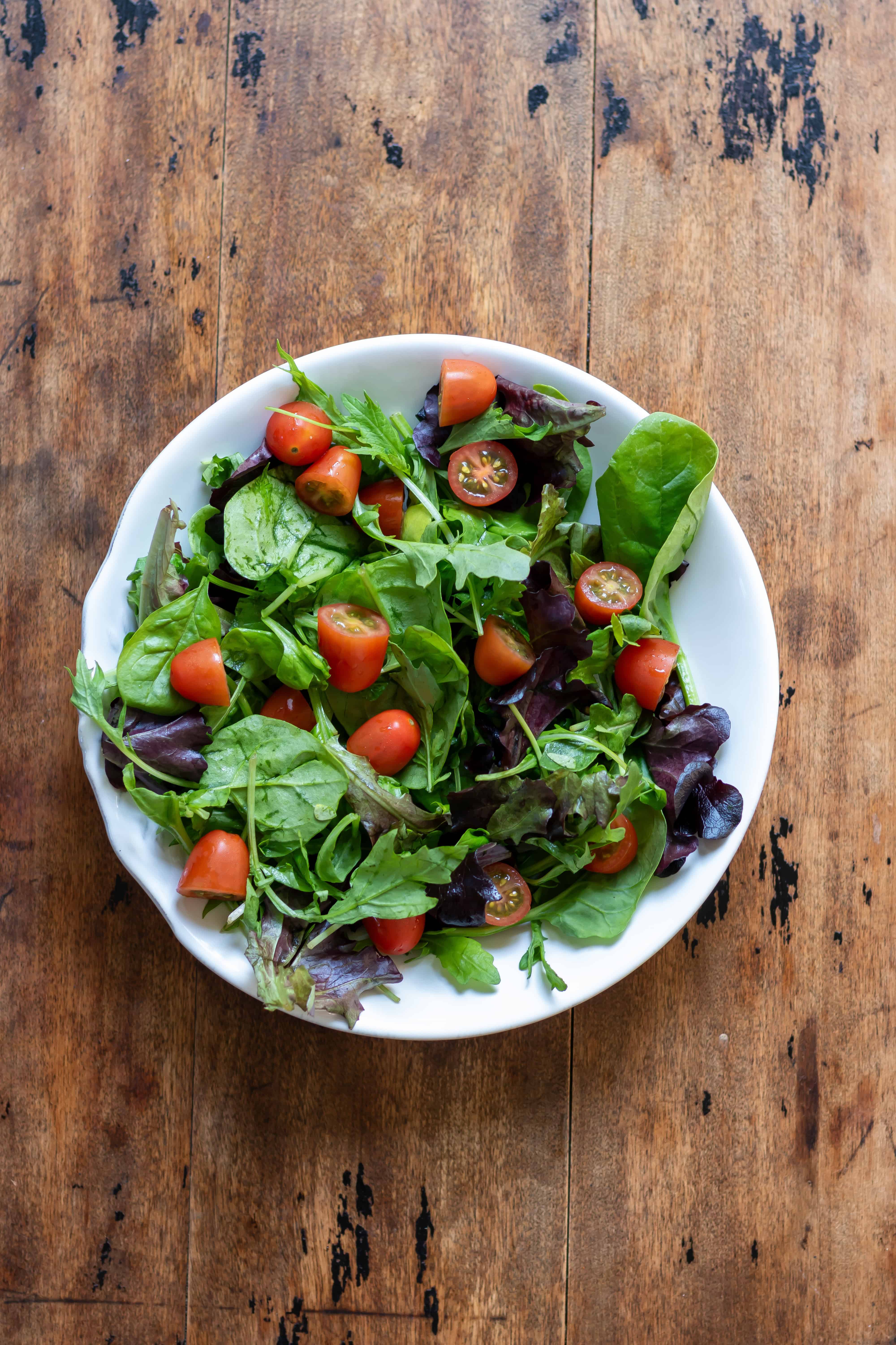 Lettuce and tomatoes in a serving dish.