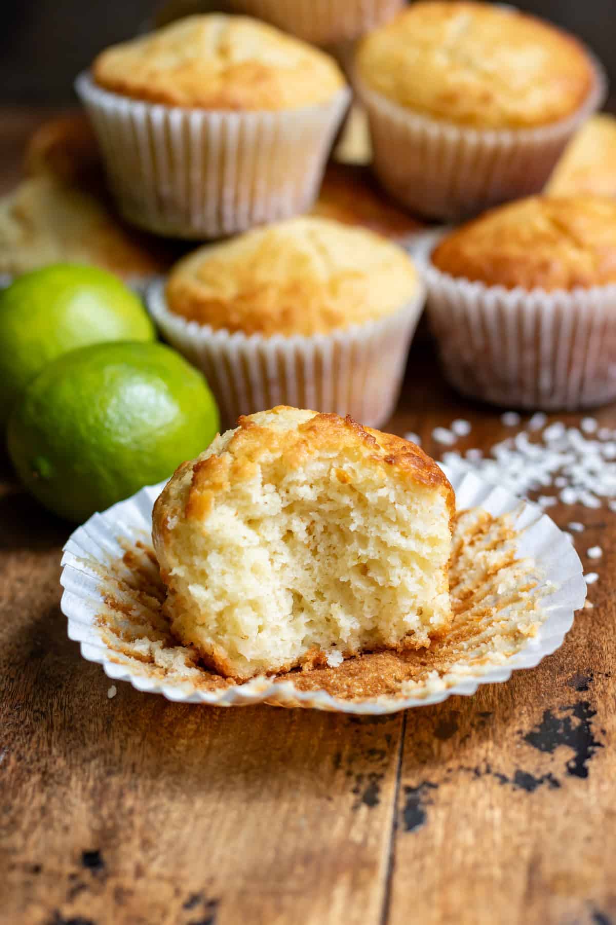 A lime coconut muffin with a bite out.