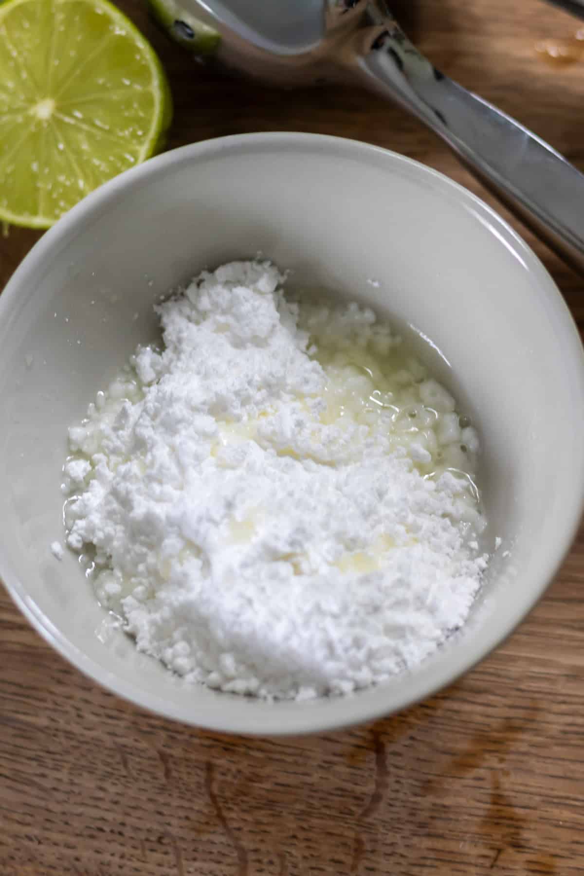Making lime glaze in a bowl.