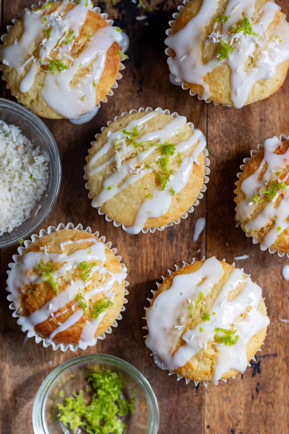 Looking down at lime coconut muffins drizzled with lime glaze.