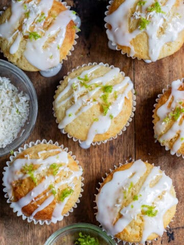 Looking down at lime coconut muffins drizzled with lime glaze.