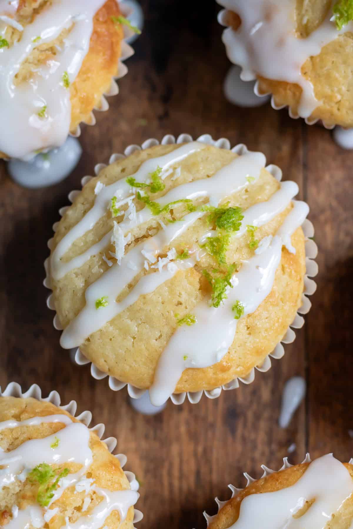 Close up of a lime coconut muffin with lime glaze.