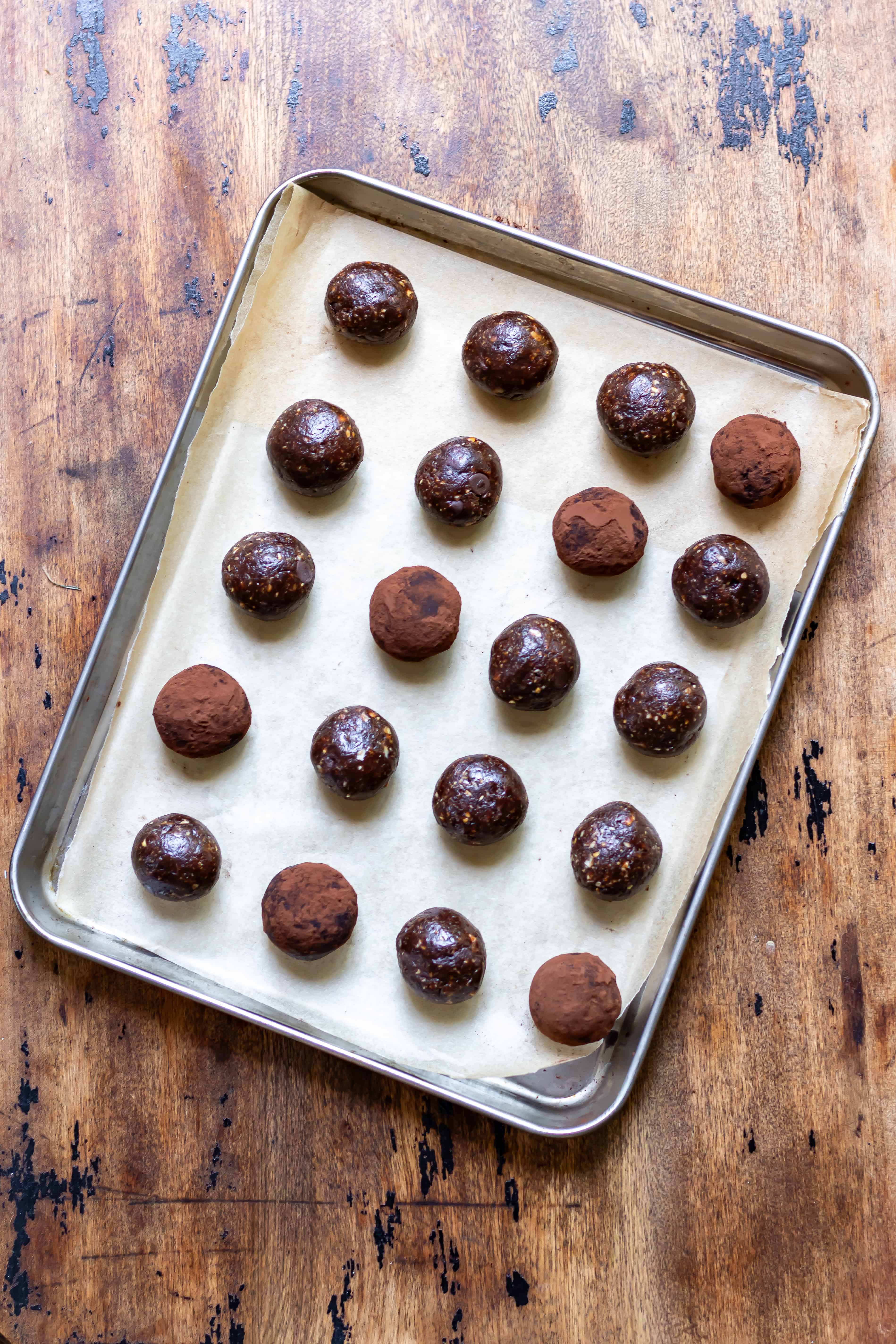A tray with rows of chocolate brownie energy balls.