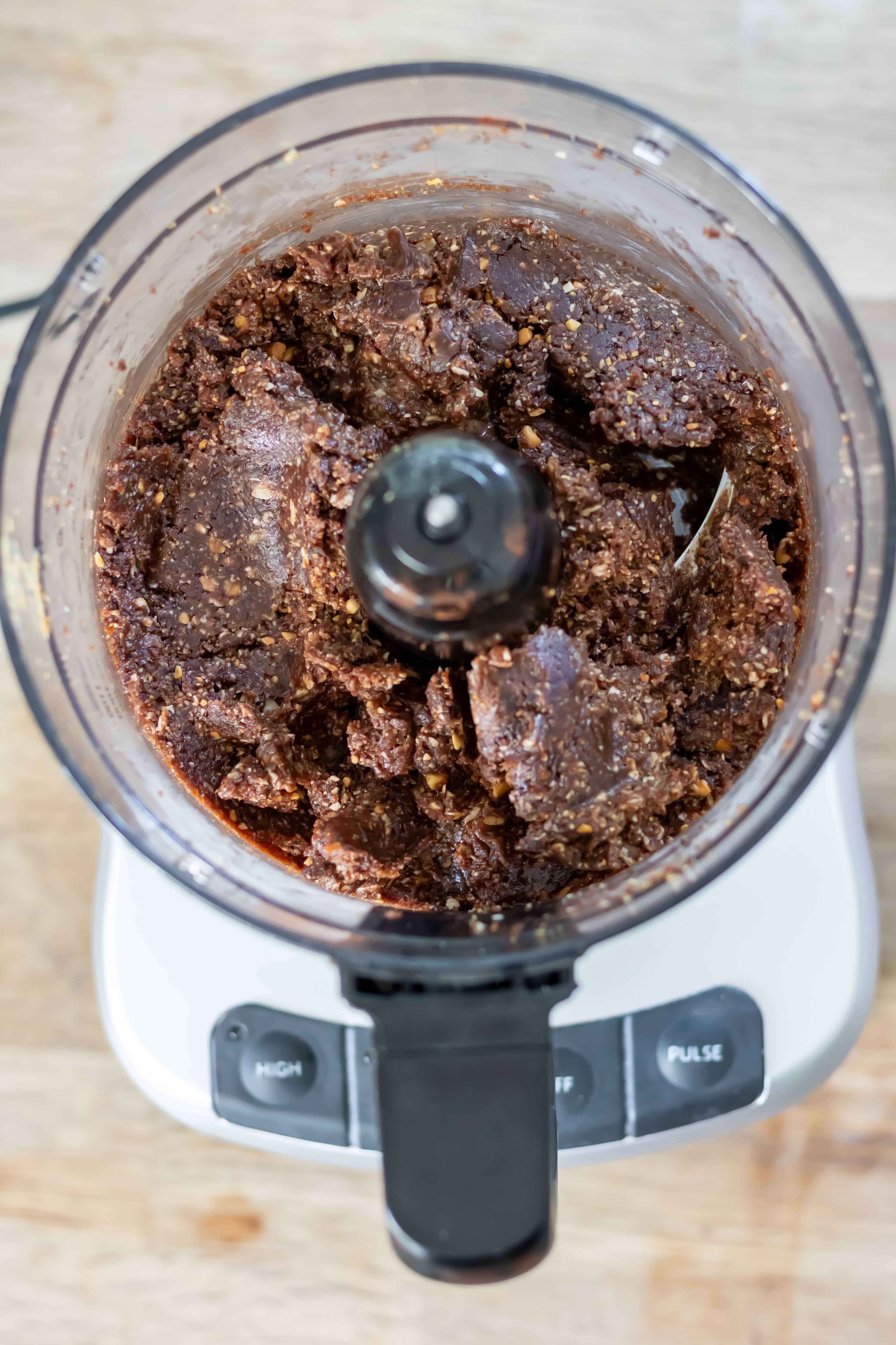 Pureed chocolate brownie energy ball mixture in the food processor.