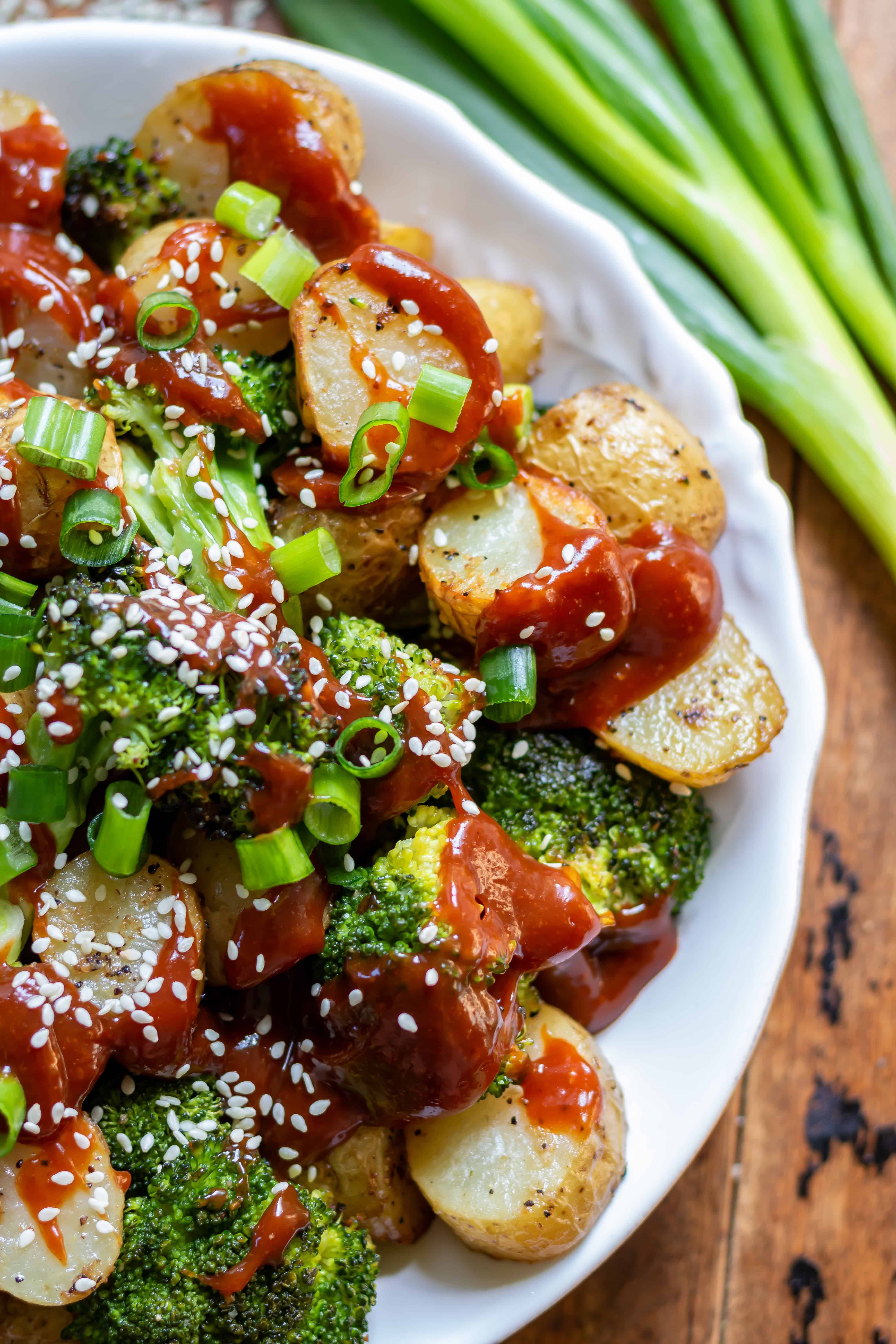 Close up of a serving dish of Gochujang Roasted Broccoli and Potatoes side dish.