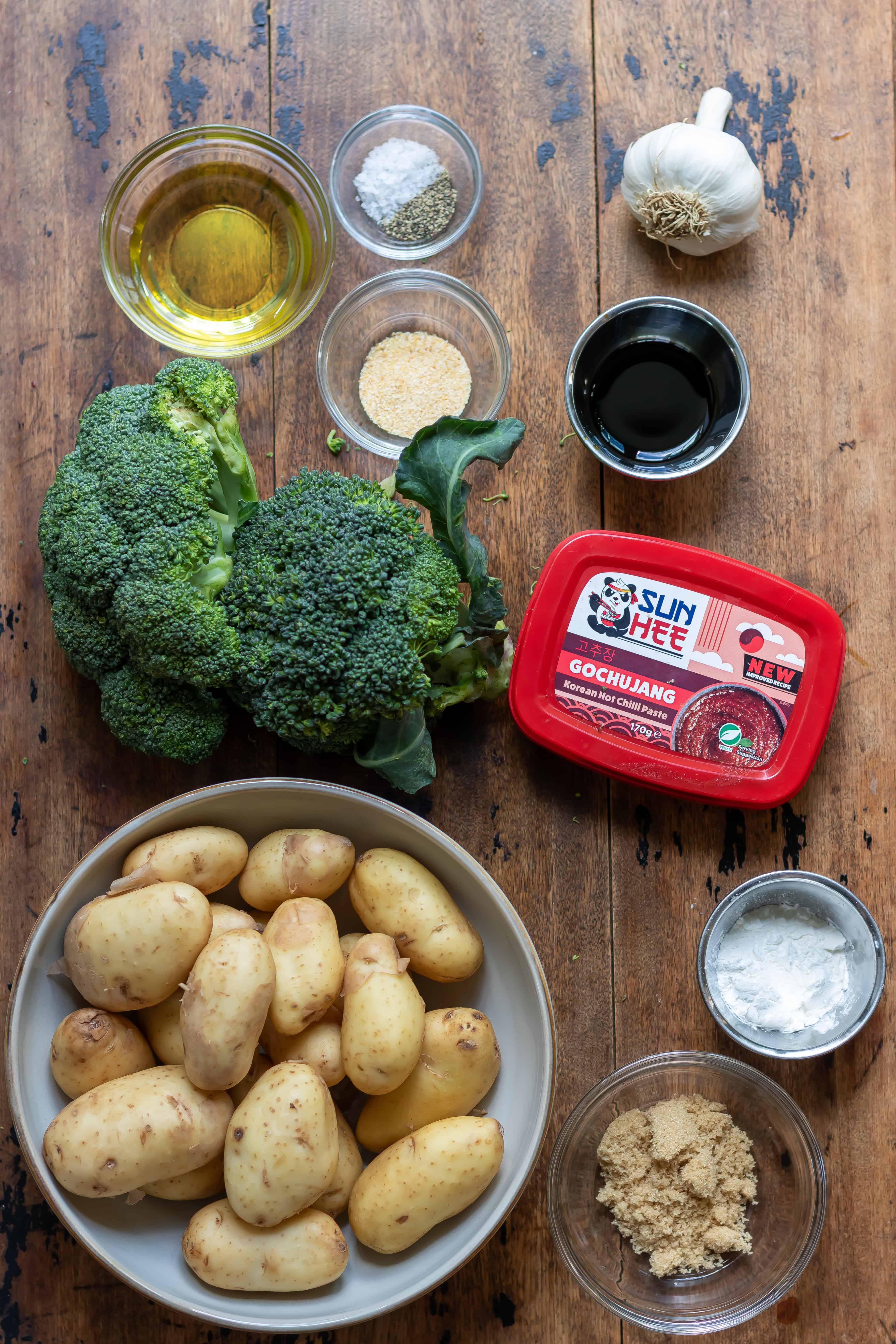 Ingredients for gochujang roasted broccoli and potatoes on a table.