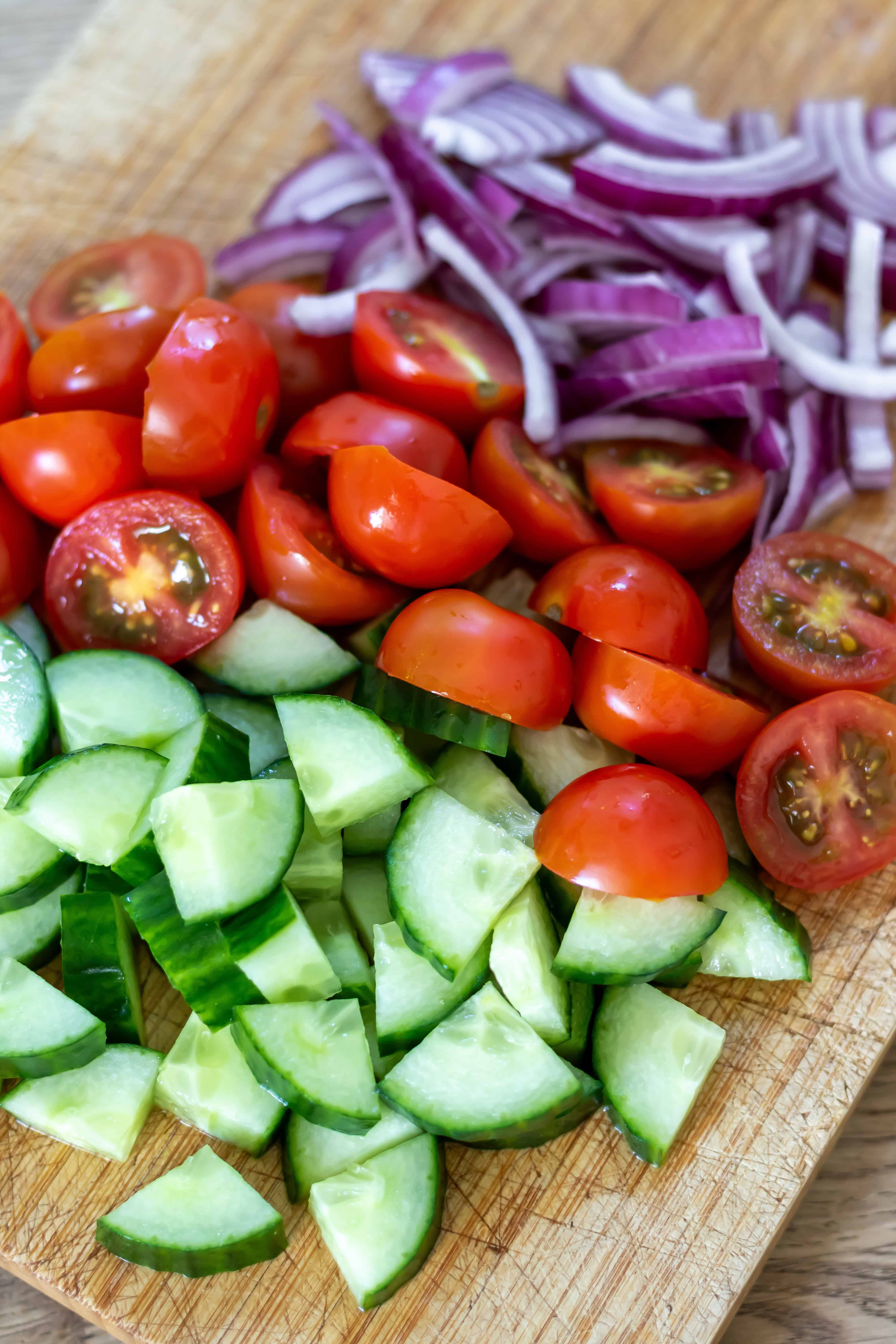 Halved baby tomatoes, sliced onions and chopped cucumbers.