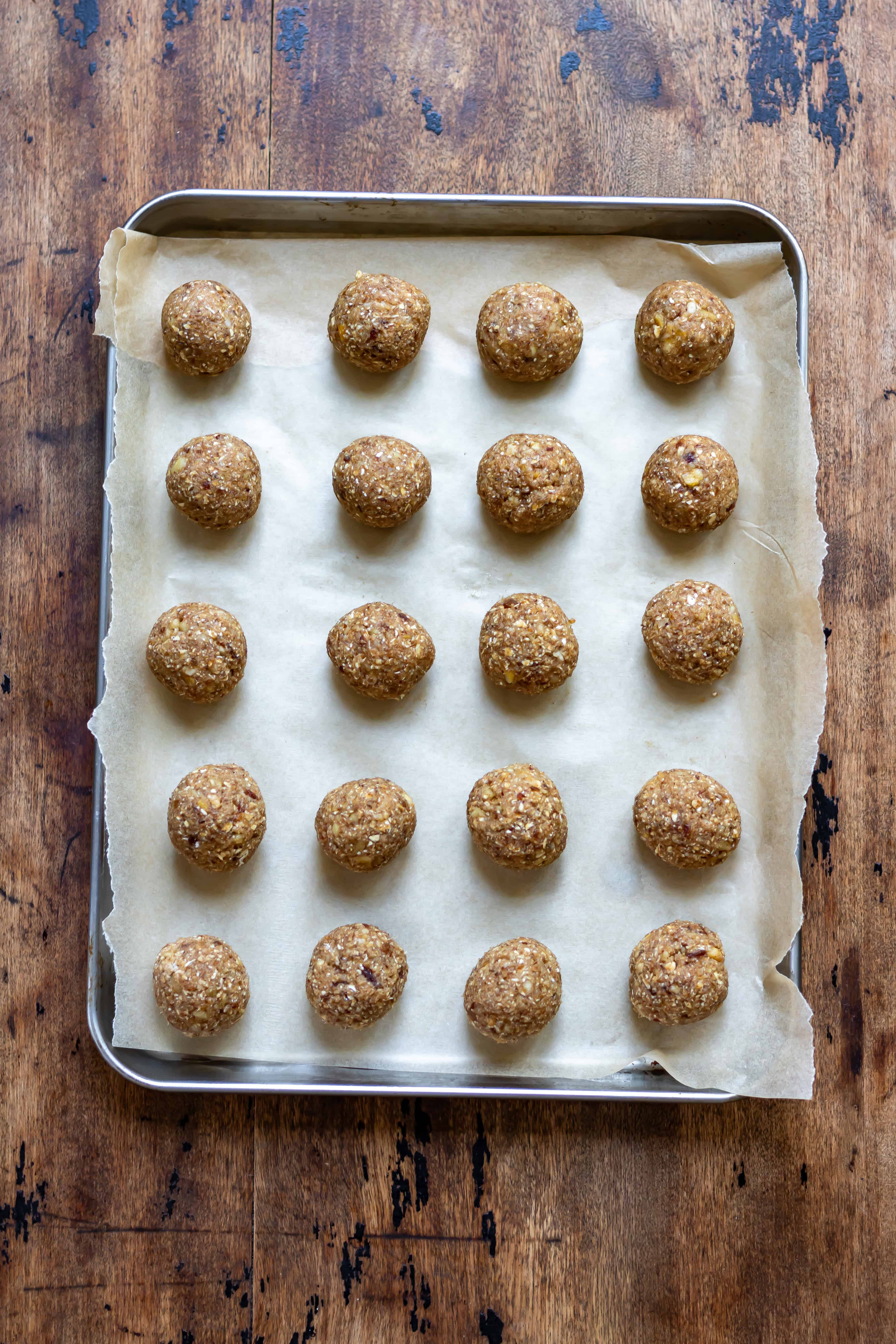 Looking down at a tray with rows of banana bread energy balls.