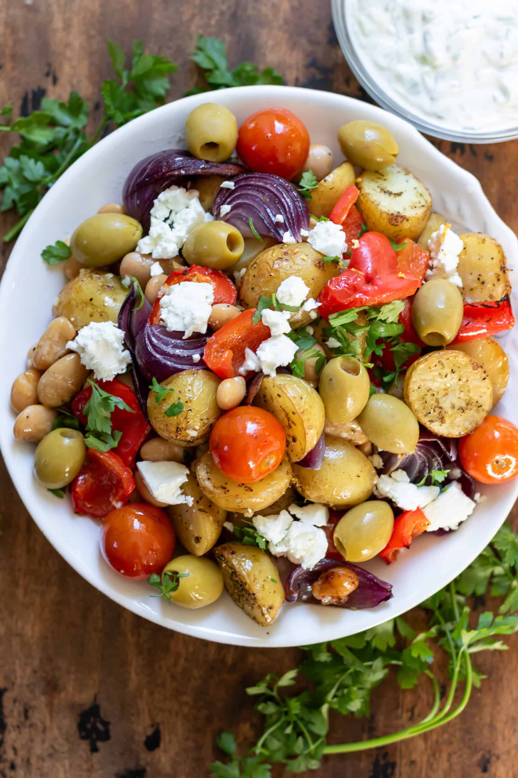 Serving dish of Greek Butter Bean Tray Bake with Potatoes, Vegetables, and Feta