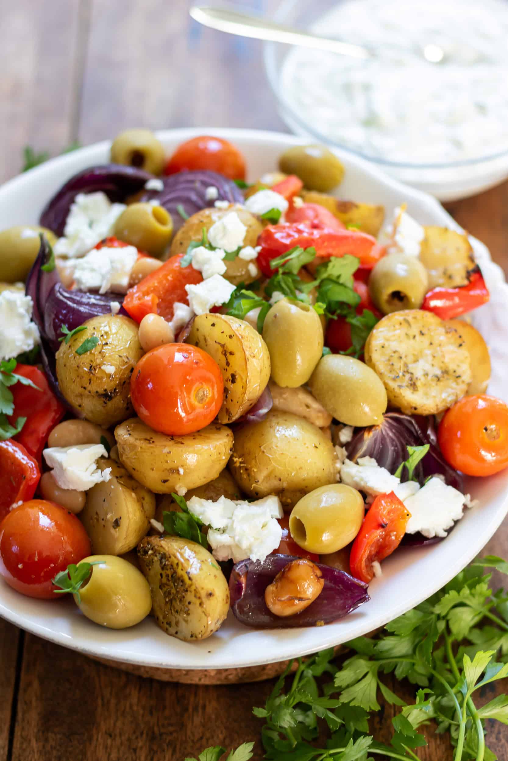Greek Butter Bean and Potato Tray Bake with olives and feta in serving dish.