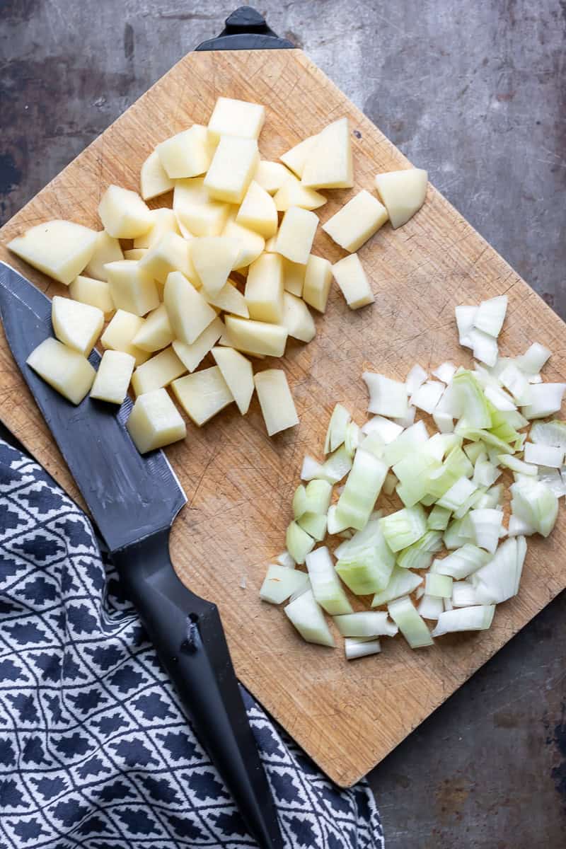 Chopping the potatoes and onions.