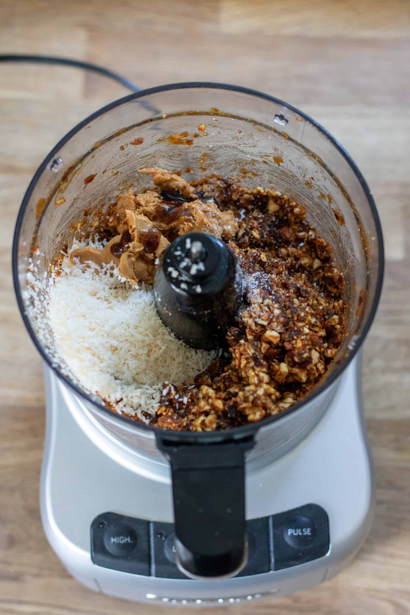 Coconut and almond butter added to the processed dates and almonds in the food processor.