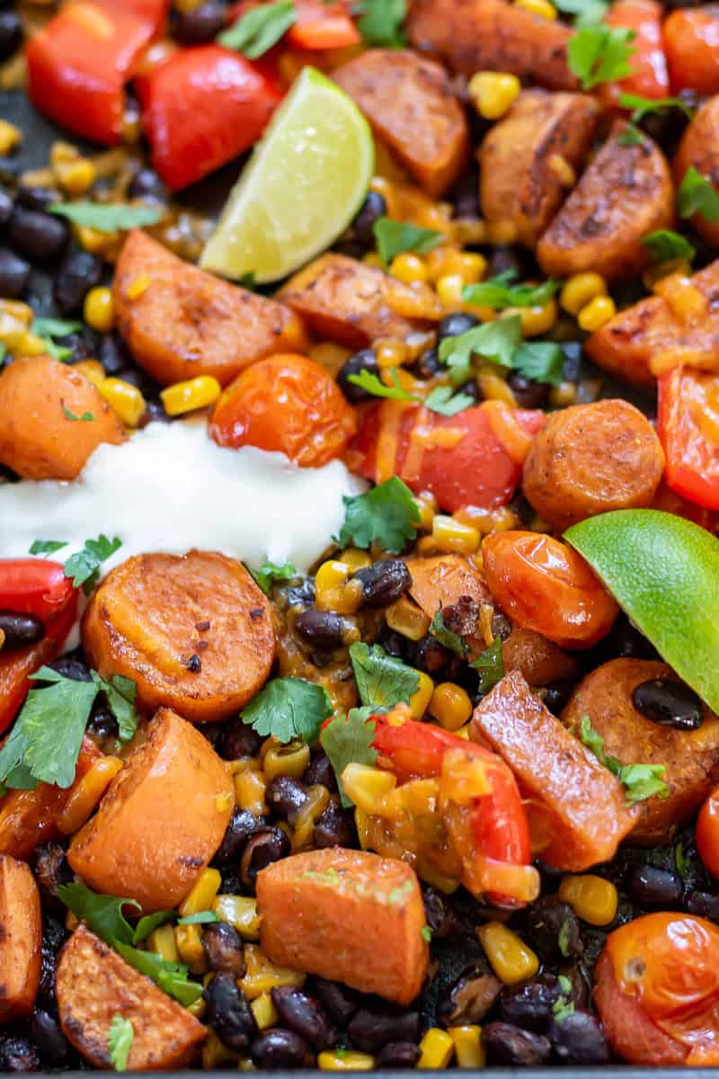 Close side view of a baking sheet of Mexican Chipotle Sweet Potato and Black Bean bake.